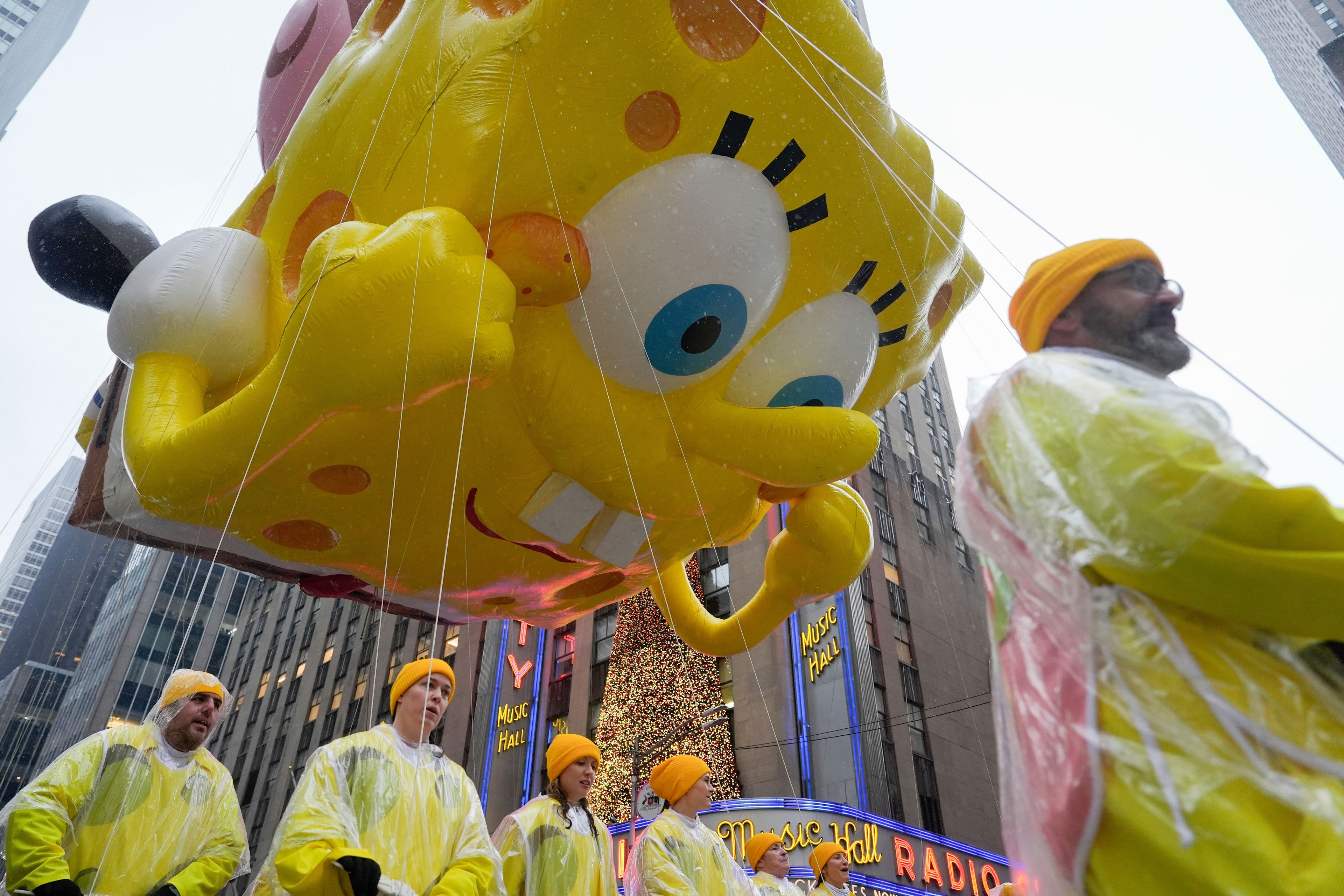 Handlers guide the SpongeBob SquarePants balloon down Sixth Avenue during the Macy's Thanksgiving Day Parade, Thursday, Nov. 28, 2024, in New York. (AP Photo/Julia Demaree Nikhinson)