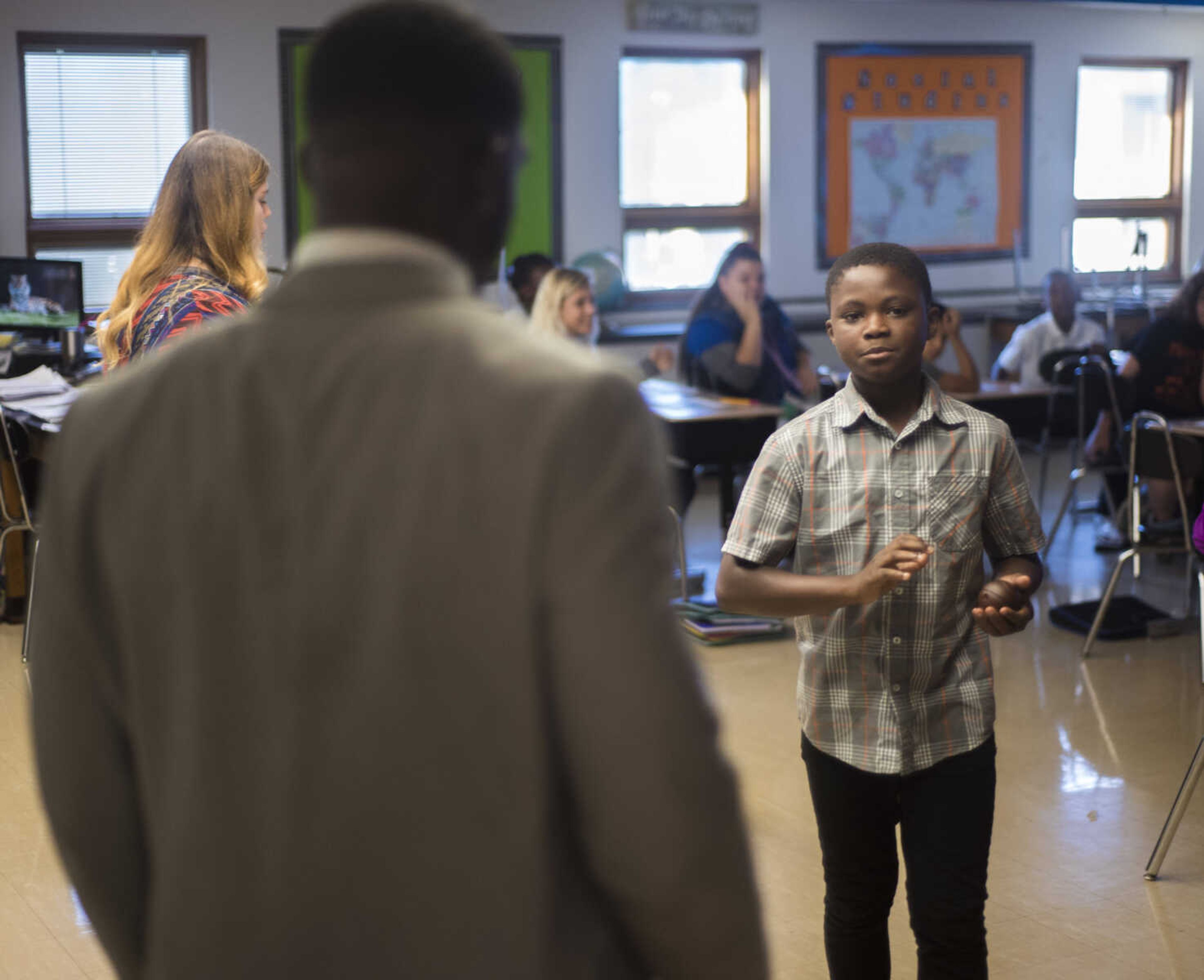 Honorable Young Mens Club leader Cantrell Andrews checks in on one of his students Sept. 19, 2017 at Central Middle School in Cape Girardeau.