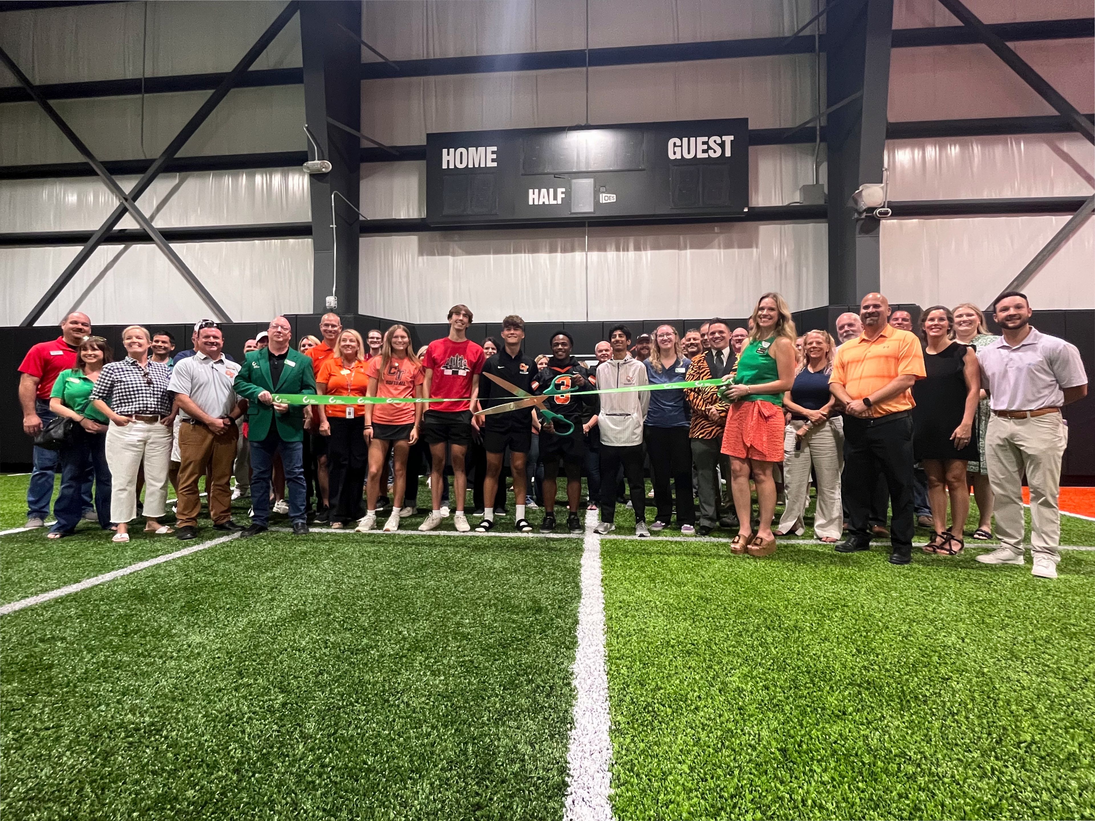 Cape Girardeau Public Schools administrators, board members, employees and students, along with Cape Girardeau Area Chamber of Commerce and community members, pose for a photo during the ribbon cutting ceremony for the district’s new Cape Tigers Training Facility on Friday, Aug. 30, at Cape Central High School. 