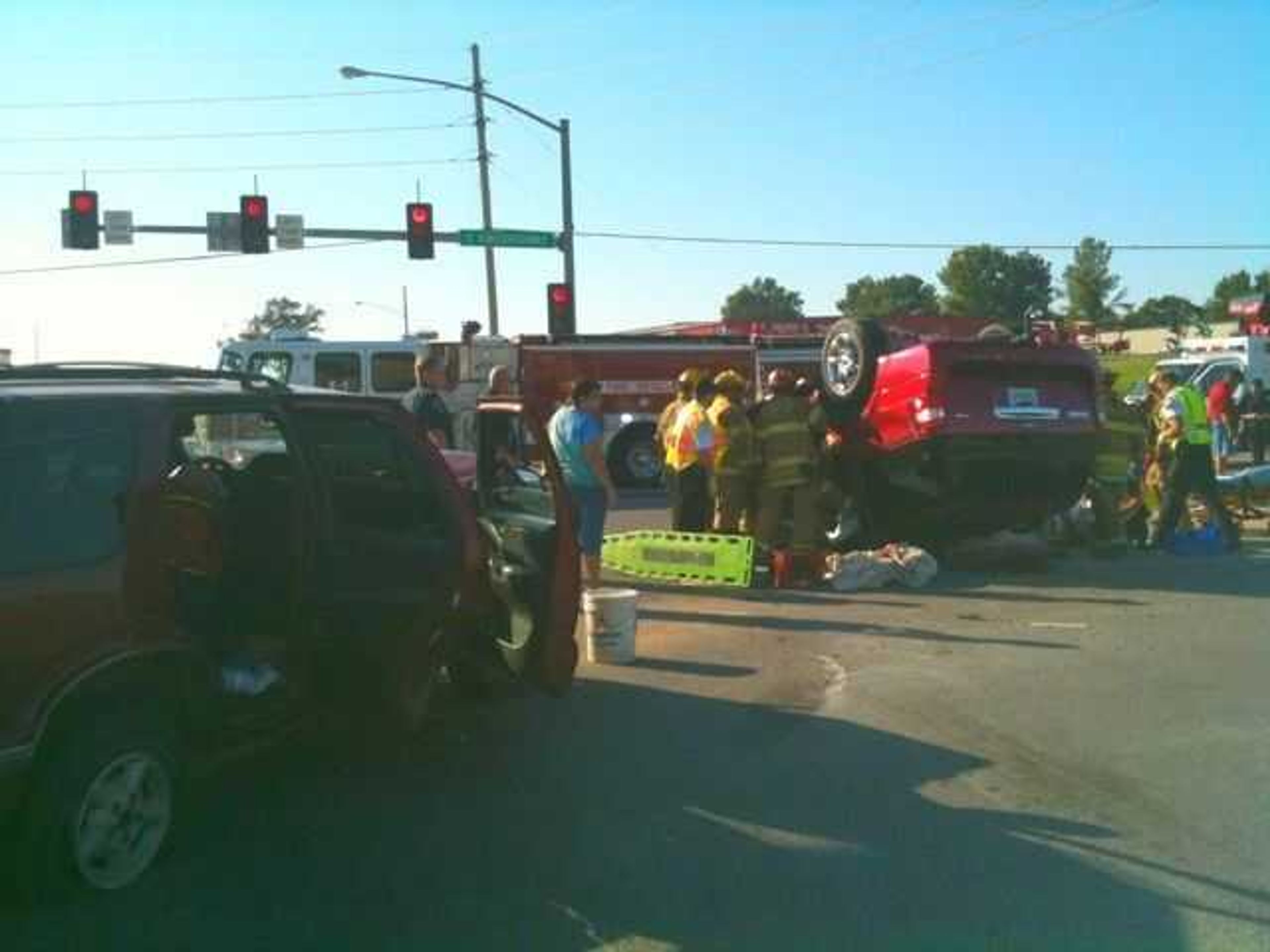 Emergency crews work to extricate one of three victims in an accident on South Kingshighway Saturday.