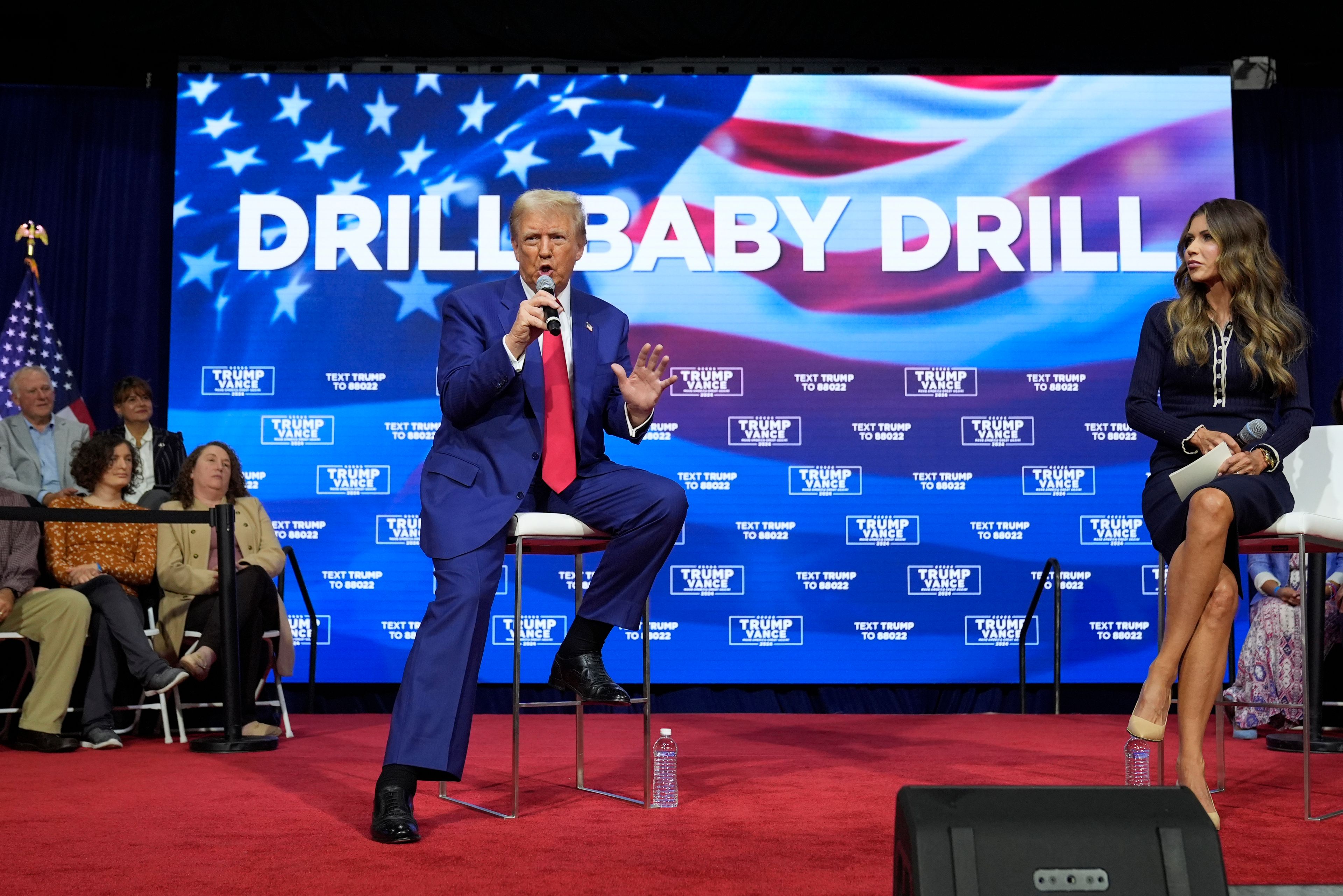 Republican presidential nominee former President Donald Trump speaks at a campaign town hall at the Greater Philadelphia Expo Center & Fairgrounds, Monday, Oct. 14, 2024, in Oaks, Pa., as moderator South Dakota Gov. Kristi Noem listens. (AP Photo/Alex Brandon)