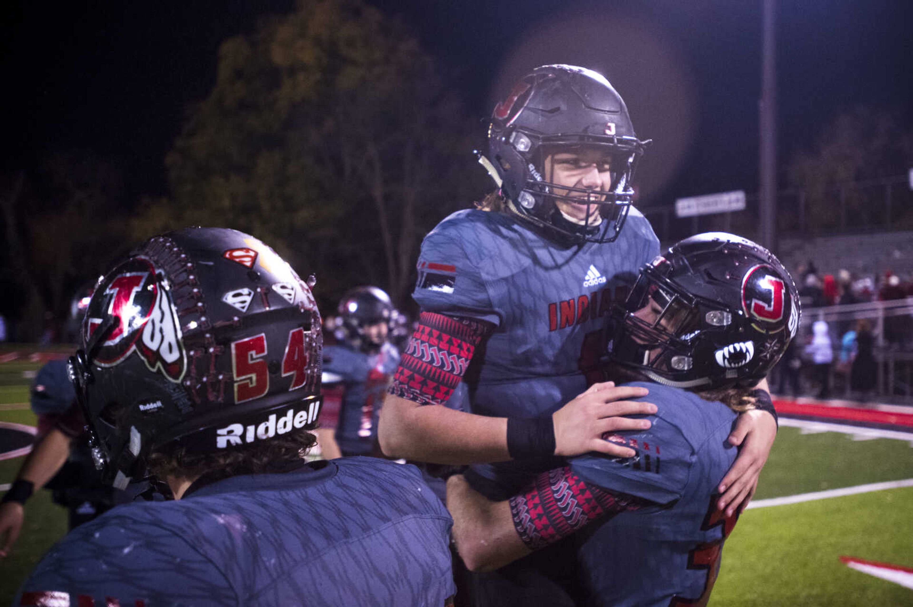 Jackson lineman Tristen Koenig, bottom right, lifts quarterback Cael Welker into the air after defeating Fox to win the district championship Friday, Nov. 9, 2018, in Jackson.