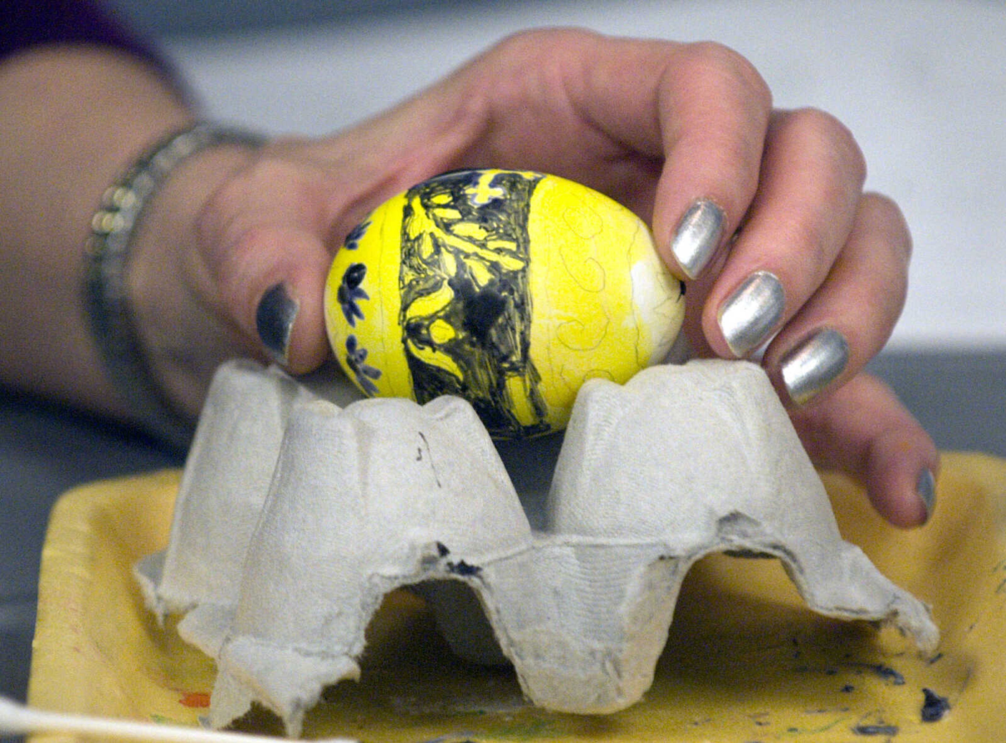 LAURA SIMON ~ lsimon@semissourian.com
A student applies dye to their egg Tuesday, March 19, 2013 during the Wonderful World of Pysanky workshop at Southeast Missouri State University's River Campus.