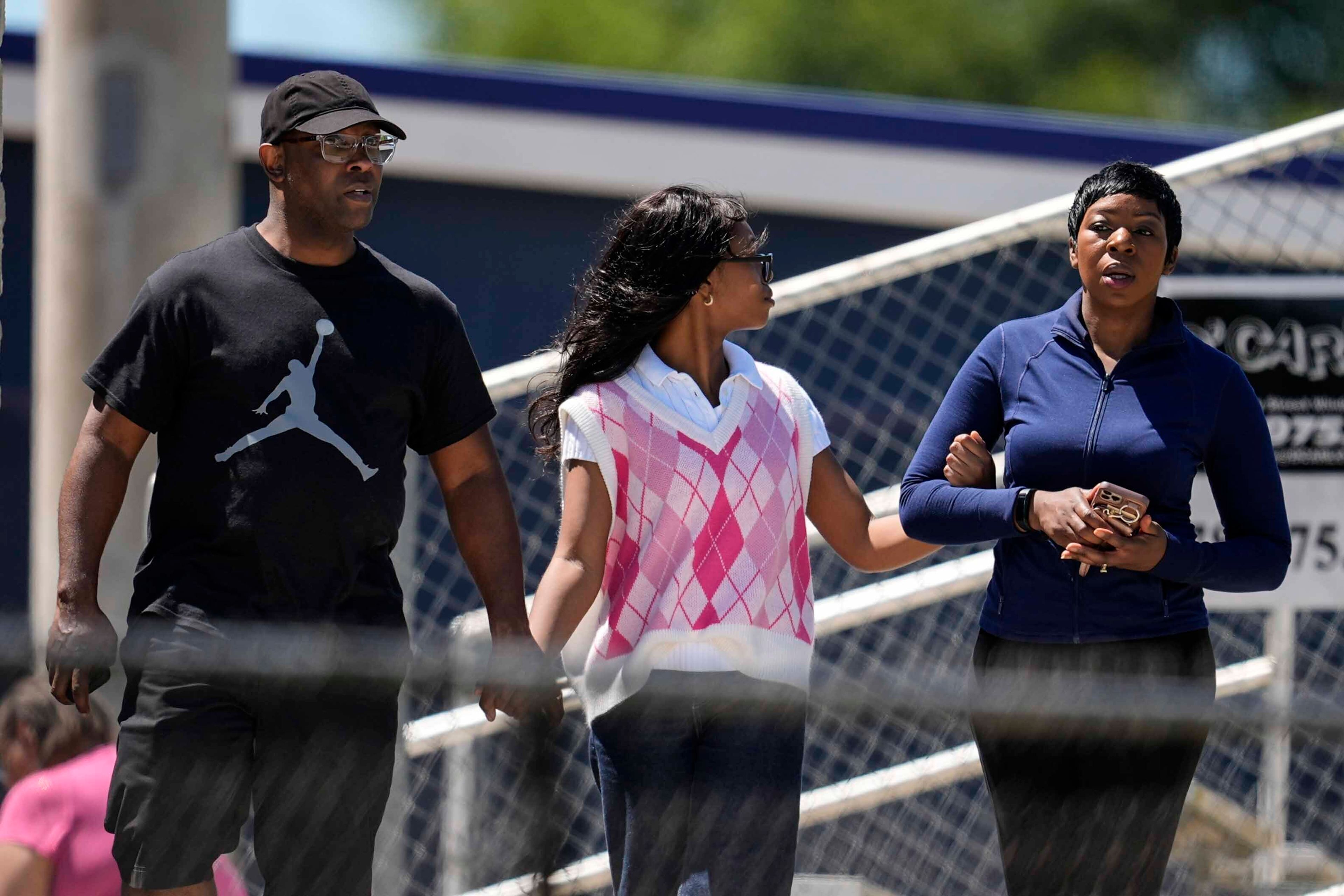 Parents walk their child out of Apalachee High School after a shooting at the school Wednesday, Sept. 4, 2024, in Winder, Ga. (AP Photo/Mike Stewart)