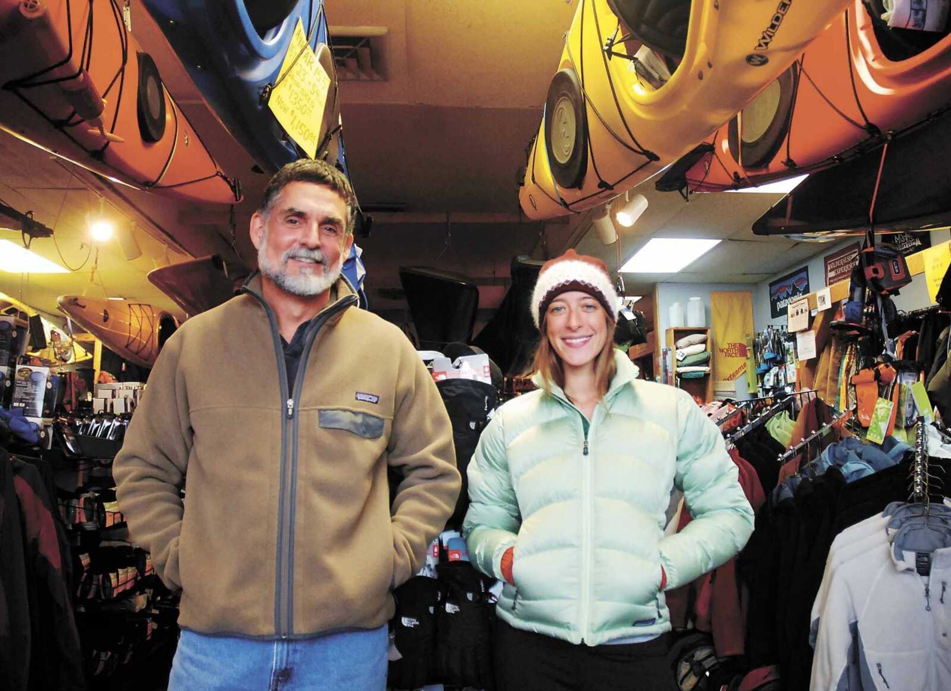 Shawnee Trails Wilderness Outfitters owner Rick Reeve, left, and employee Kyle Teague modeled Patagonia jackets Dec. 13 in the Carbondale, Ill., store. The jackets are popular gifts. (Amanda Whitlock ~ The Southern Illinoisan)