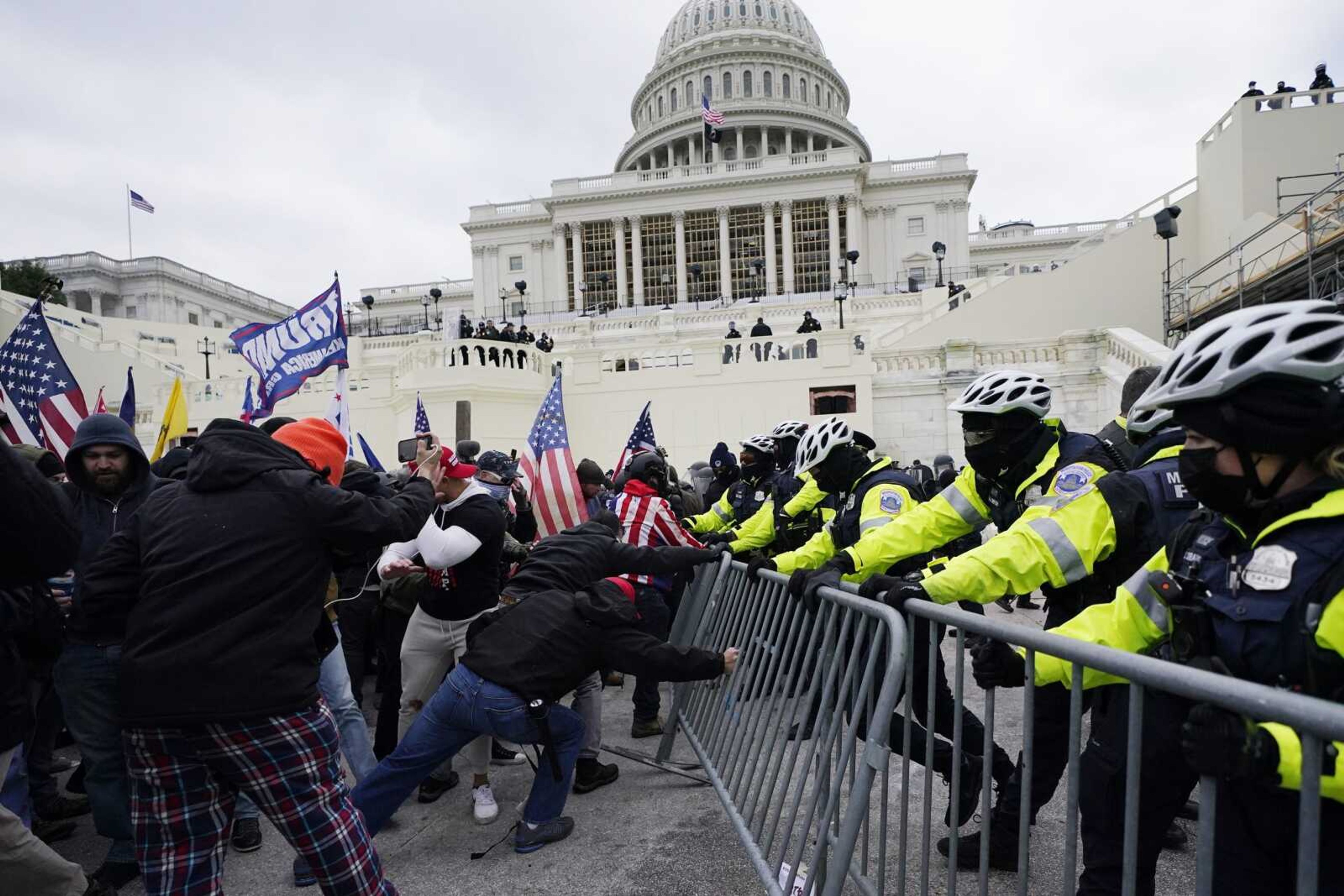 Insurrectionists loyal to President Donald Trump try to break through a police barrier Jan. 6, 2021, at the Capitol in Washington. Facing prison time and dire personal consequences for storming the U.S. Capitol, some Jan. 6 defendants are trying to profit from their participation in the riot, using it as a platform to drum up cash, promote business endeavors and boost social media profiles.