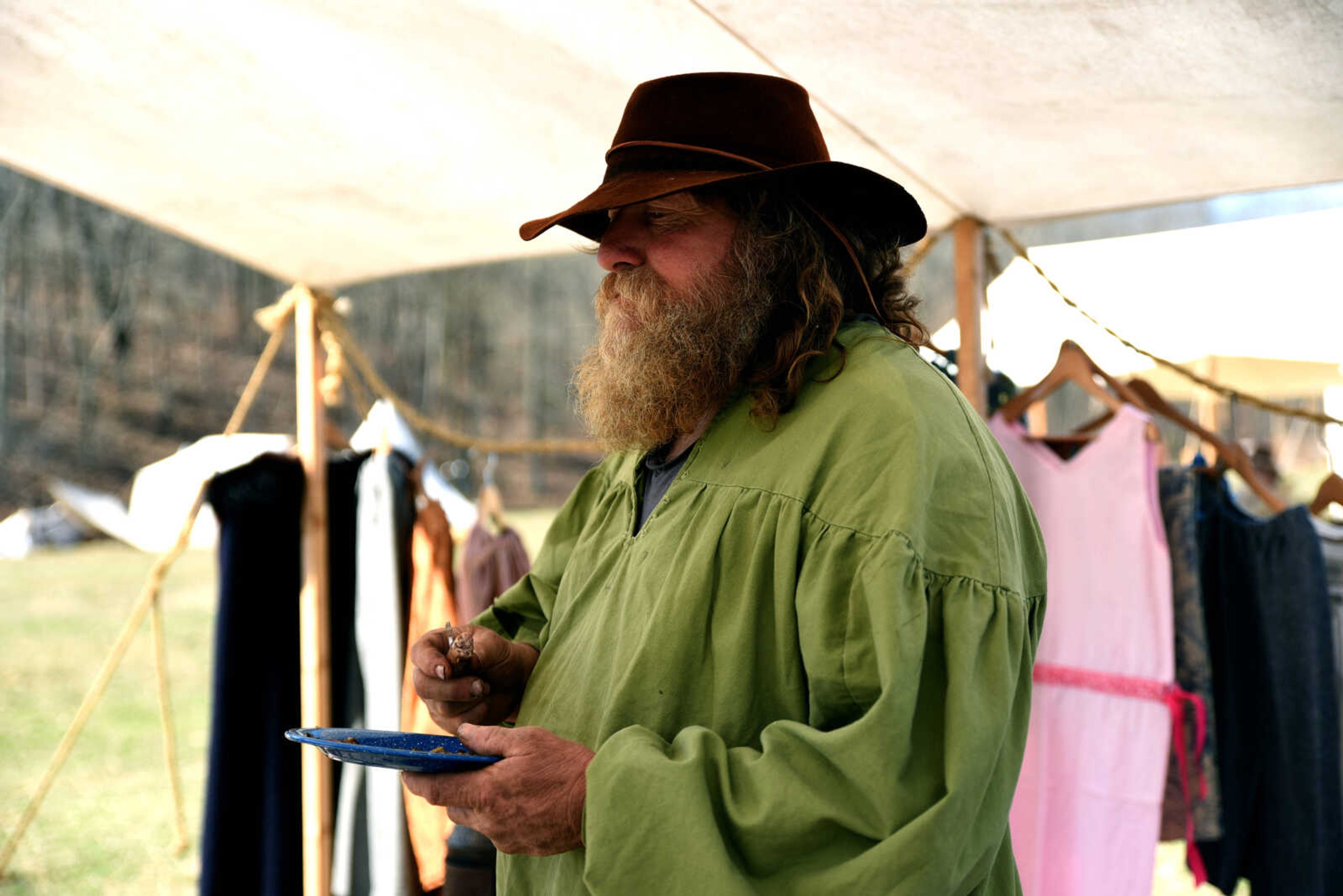 Don Riggs, who goes by SkunkHead, eats bacon, potatoes and sausage that he cooked during the second annual Eastern Ozark Rendezvous held at Bark's Planation Saturday, March 17, 2018, in Glenallen.