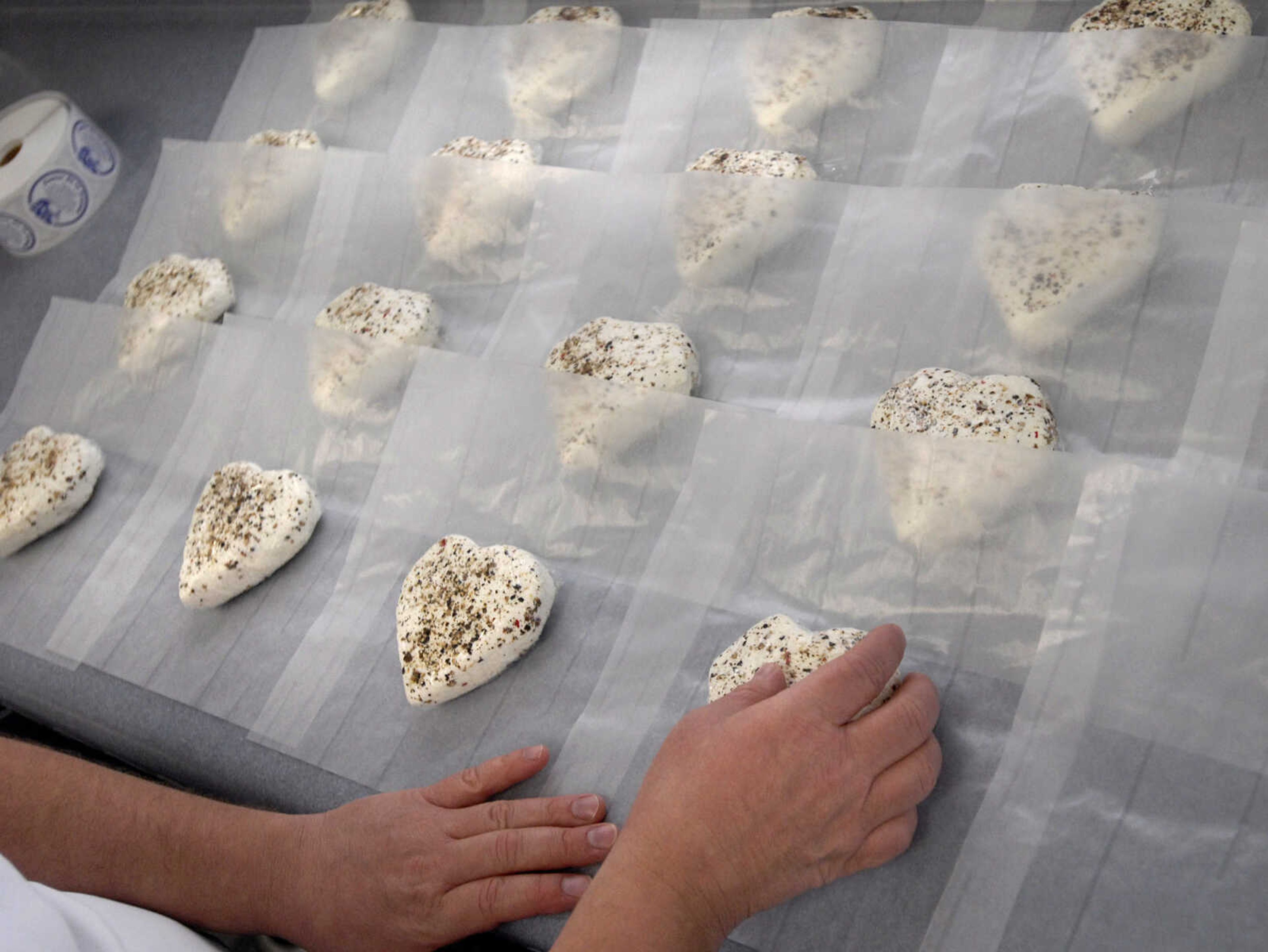 LAURA SIMON ~ lsimon@semissourian.com
LaVonne Leach packages heart shaped Coeur de la Creme, pure artisan goat cheese Wednesday, Dec. 14, 2011 at Baetje Farms in Bloomsdale, Mo. The goat cheese was seasoned using organic fresh ground pepper just before packaging.