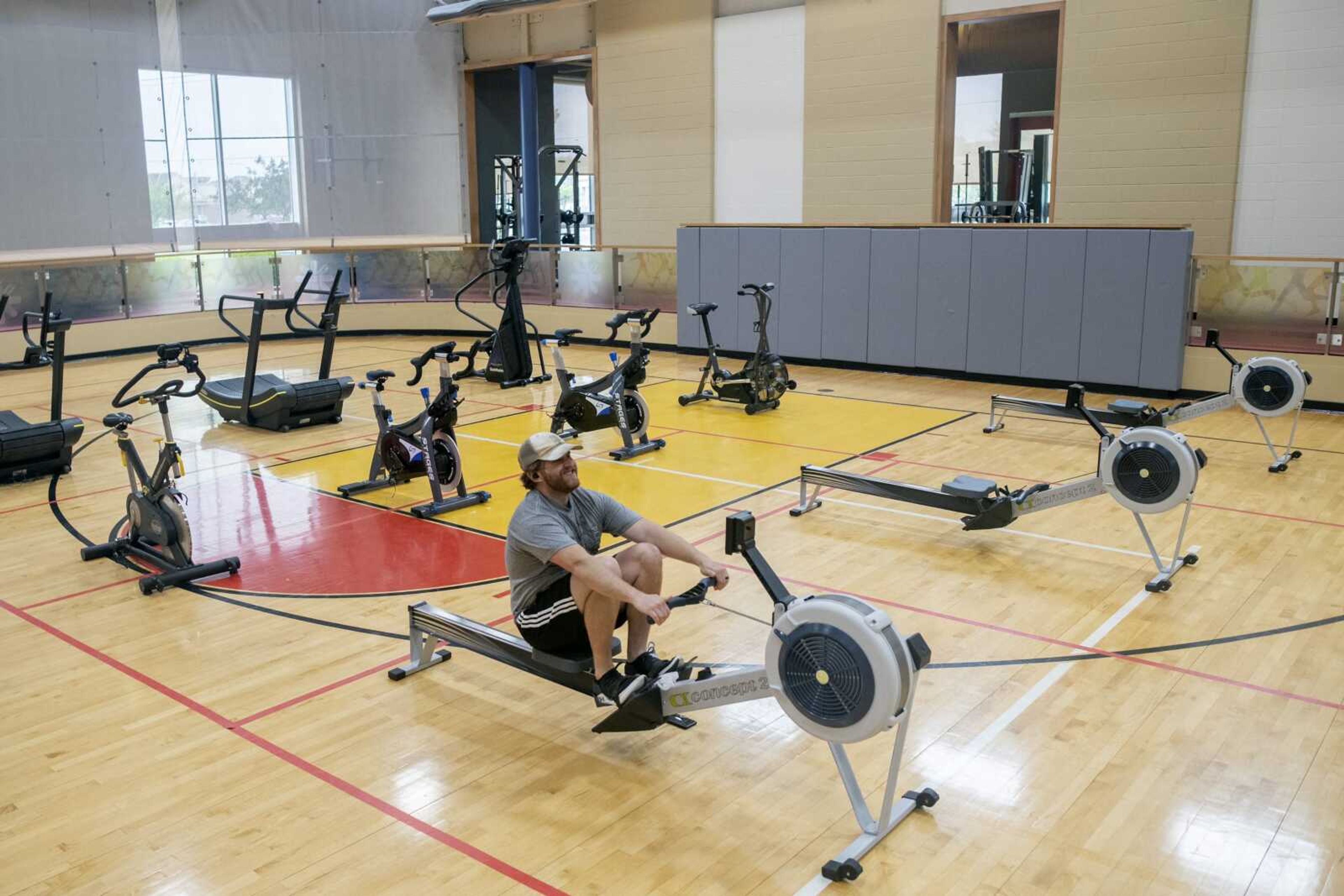 Adam Smithey of McClure, Illinois, works out on machines placed on a basketball court Tuesday at Southeast HealthPoint Fitness in Cape Girardeau.