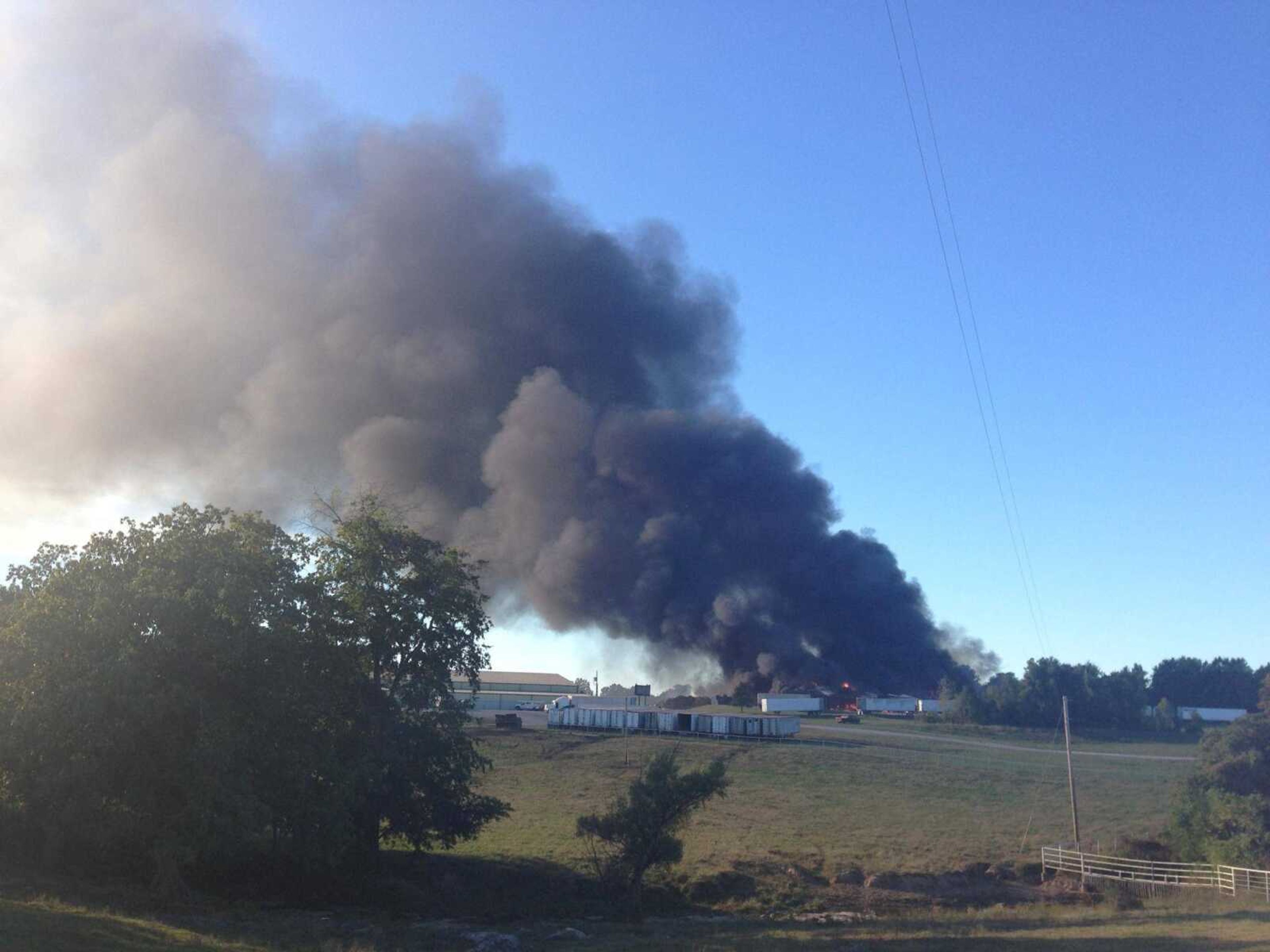 This cellphone photo shows smoke billowing from the scene of a fire at a sawmill near Flickerwood Arena near Fruitland. (Adam Vogler)