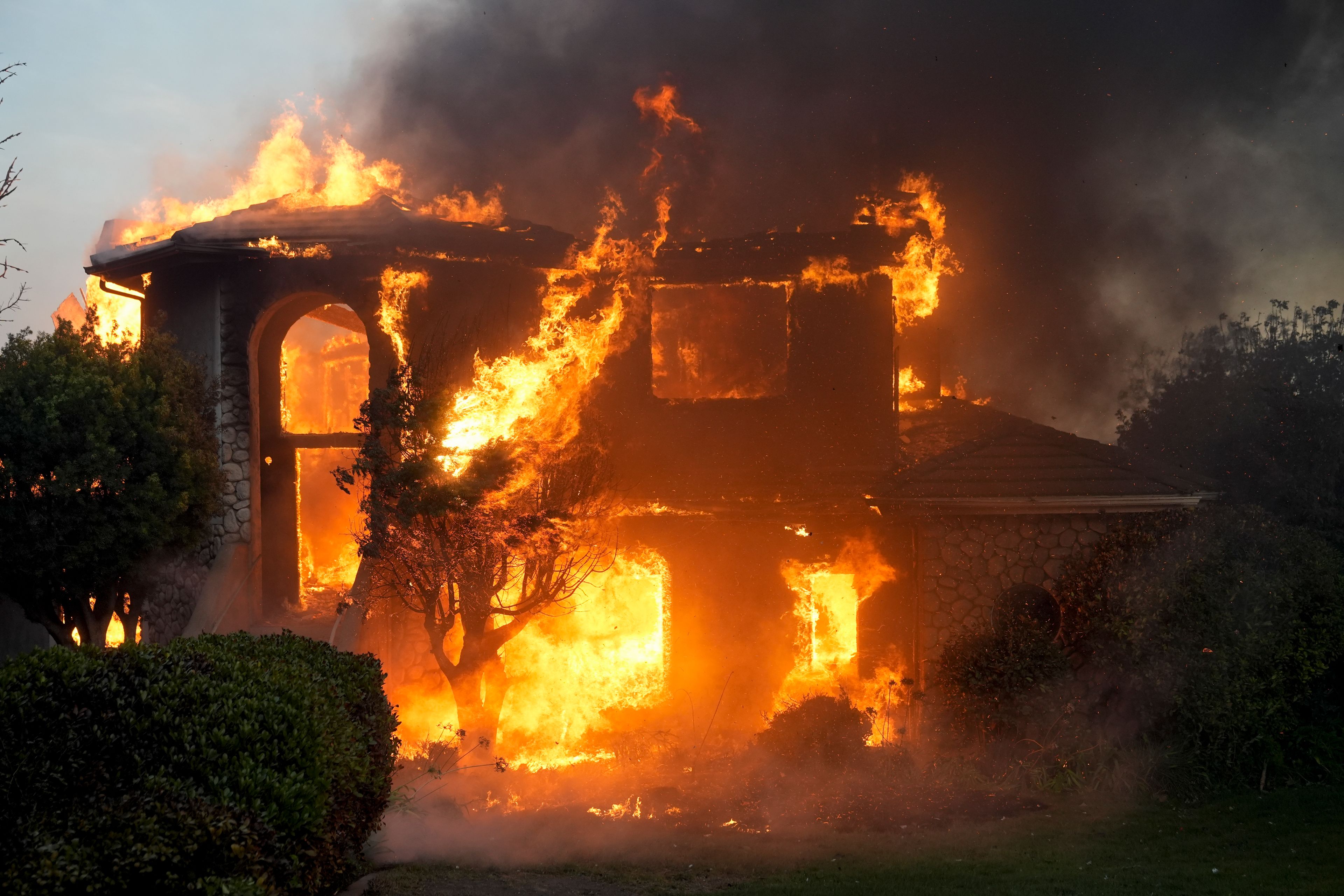 A fire burns a house in the Mountain fire, Wednesday, Nov. 6, 2024, in Camarillo, Calif. (AP Photo/Marcio Jose Sanchez)