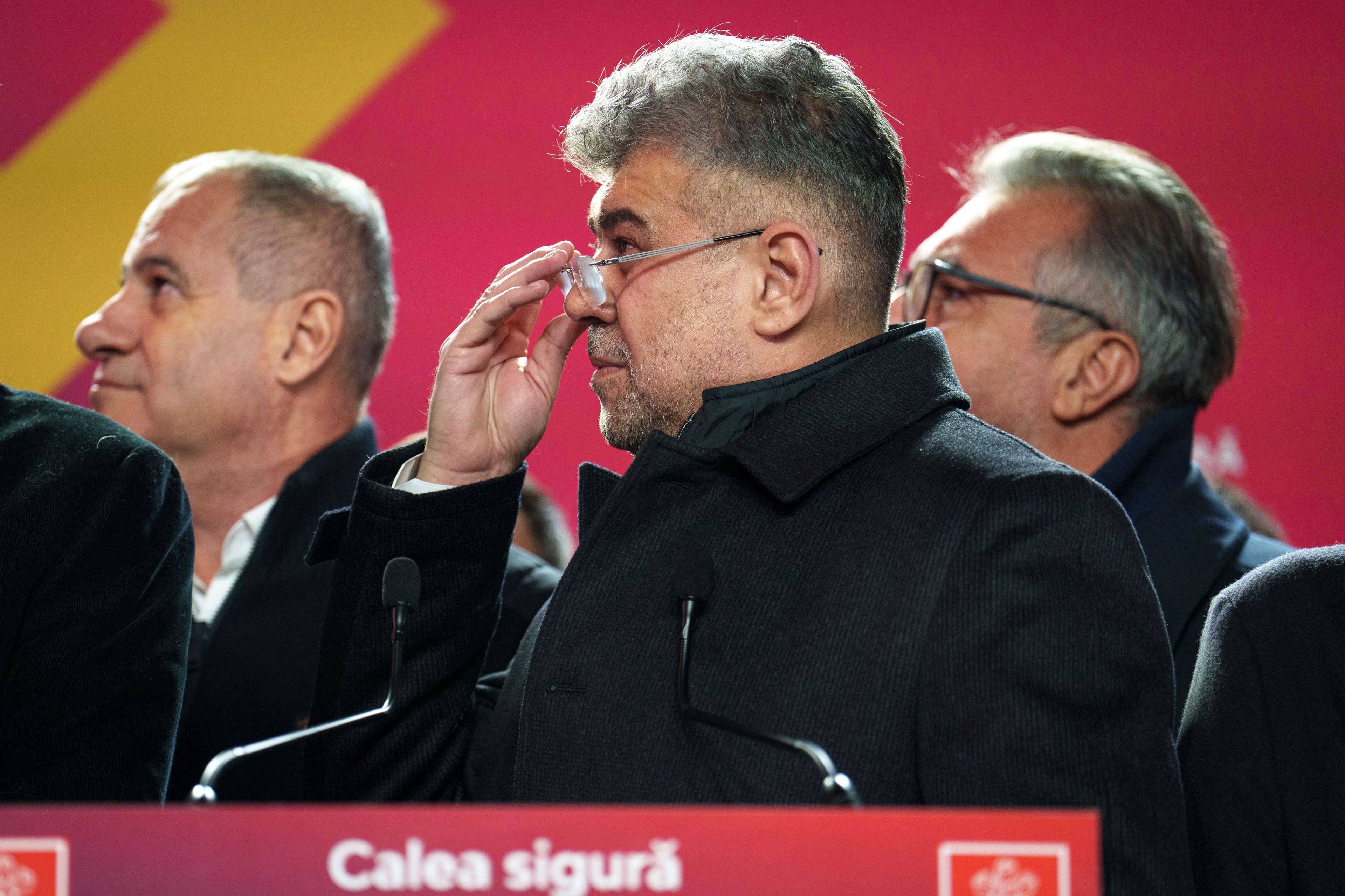 Romanian Prime Minister Marcel Ciolacu, the Social Democratic Party or PSD candidate in the country's presidential elections, removes his glasses while waching exit polls after voting ended, in Bucharest, Romania, Sunday, Nov. 24, 2024. (AP Photo/Vadim Ghirda)