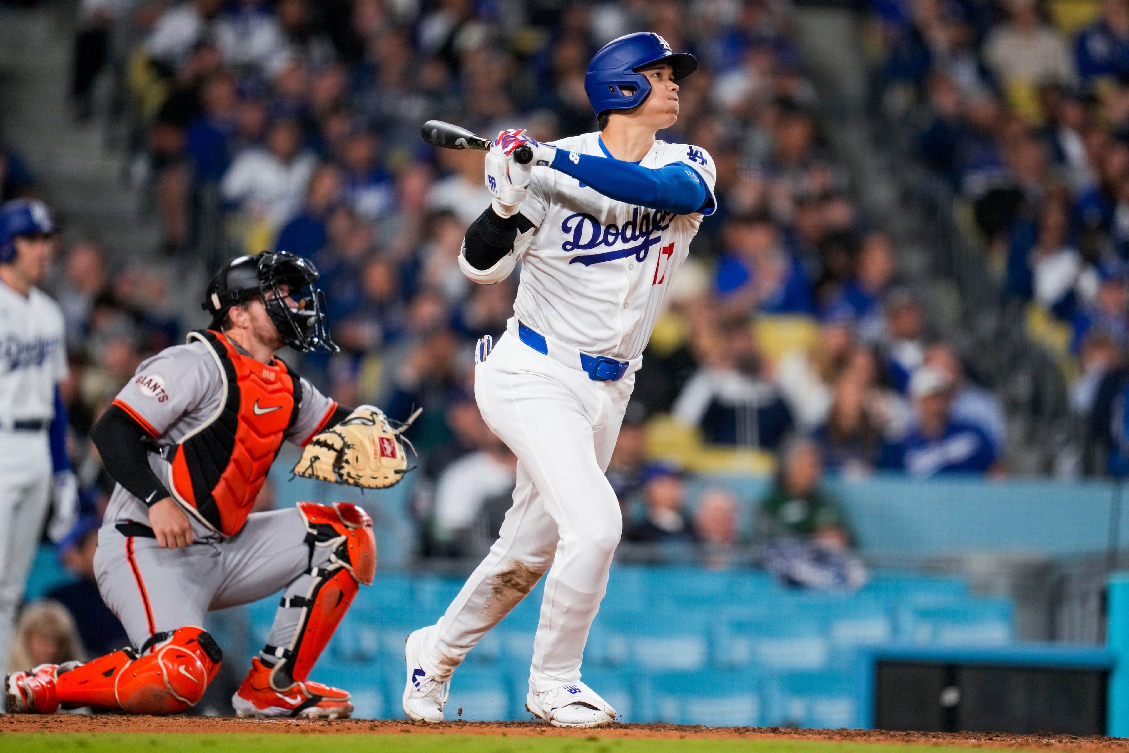 Los Angeles Dodgers designated hitter Shohei Ohtani hits a home run during the seventh inning of a baseball game against the San Francisco Giants in Los Angeles, Wednesday, April 3, 2024. (AP Photo/Ashley Landis)