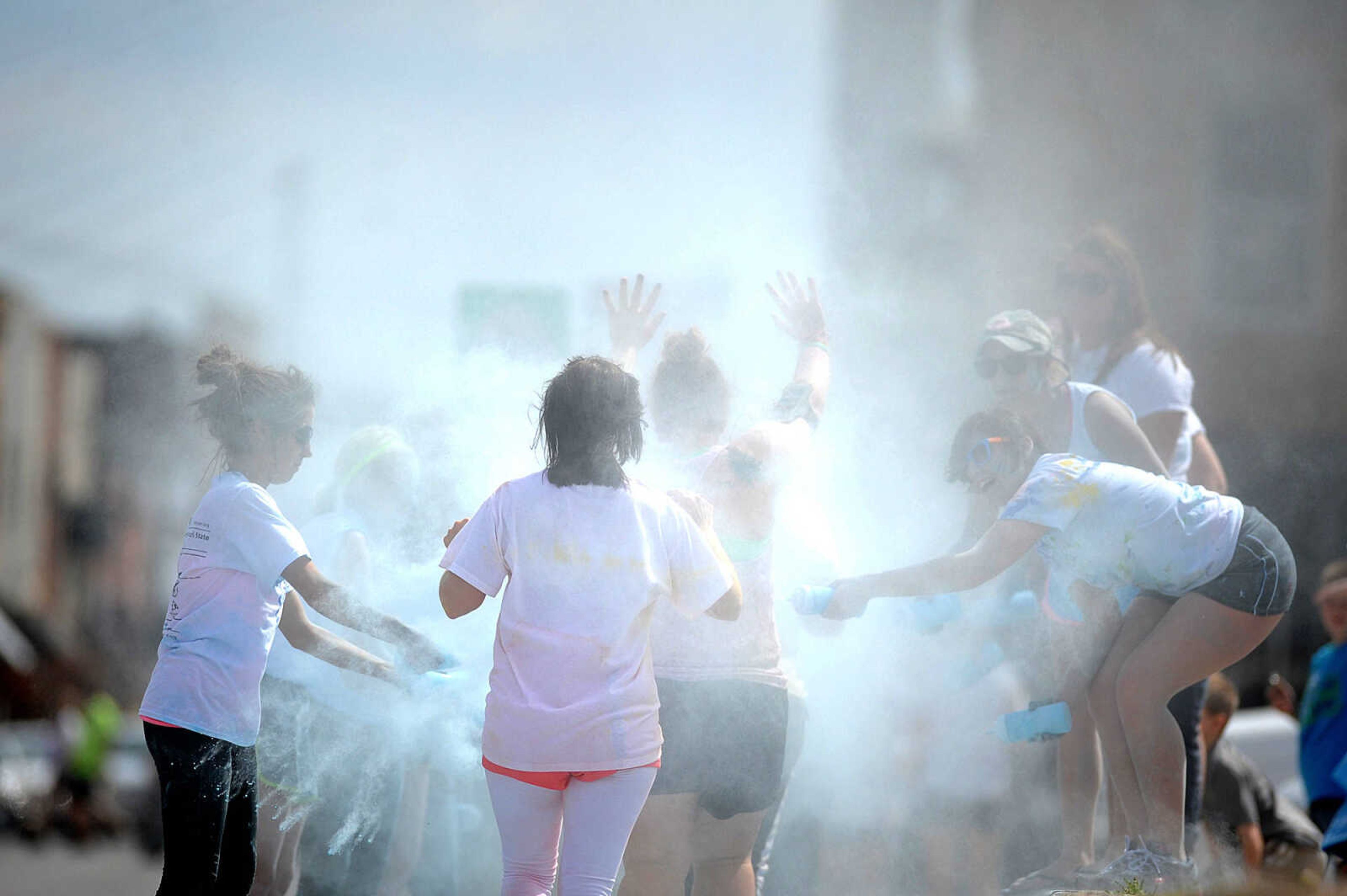 LAURA SIMON ~ lsimon@semissourian.com

Participants in the Color Me Cape 5K are sprayed with blue powder at the final color station on Main Street, Saturday, April 12, 2014, in Cape Girardeau.