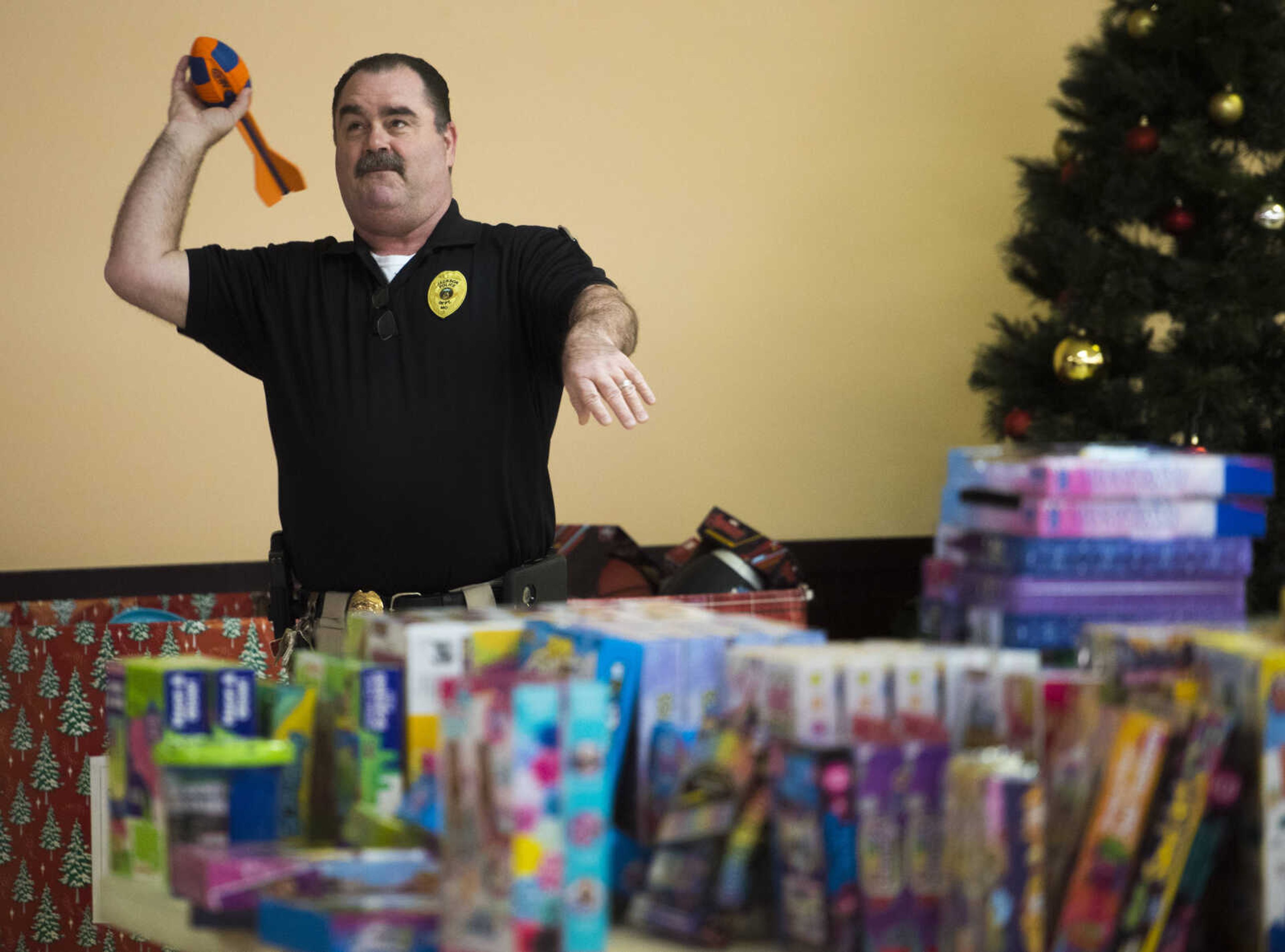 Jackson police chief Scott Eakers tests out a toy football Friday, Dec. 15, 2017, at Elks Lodge #2652 in Jackson