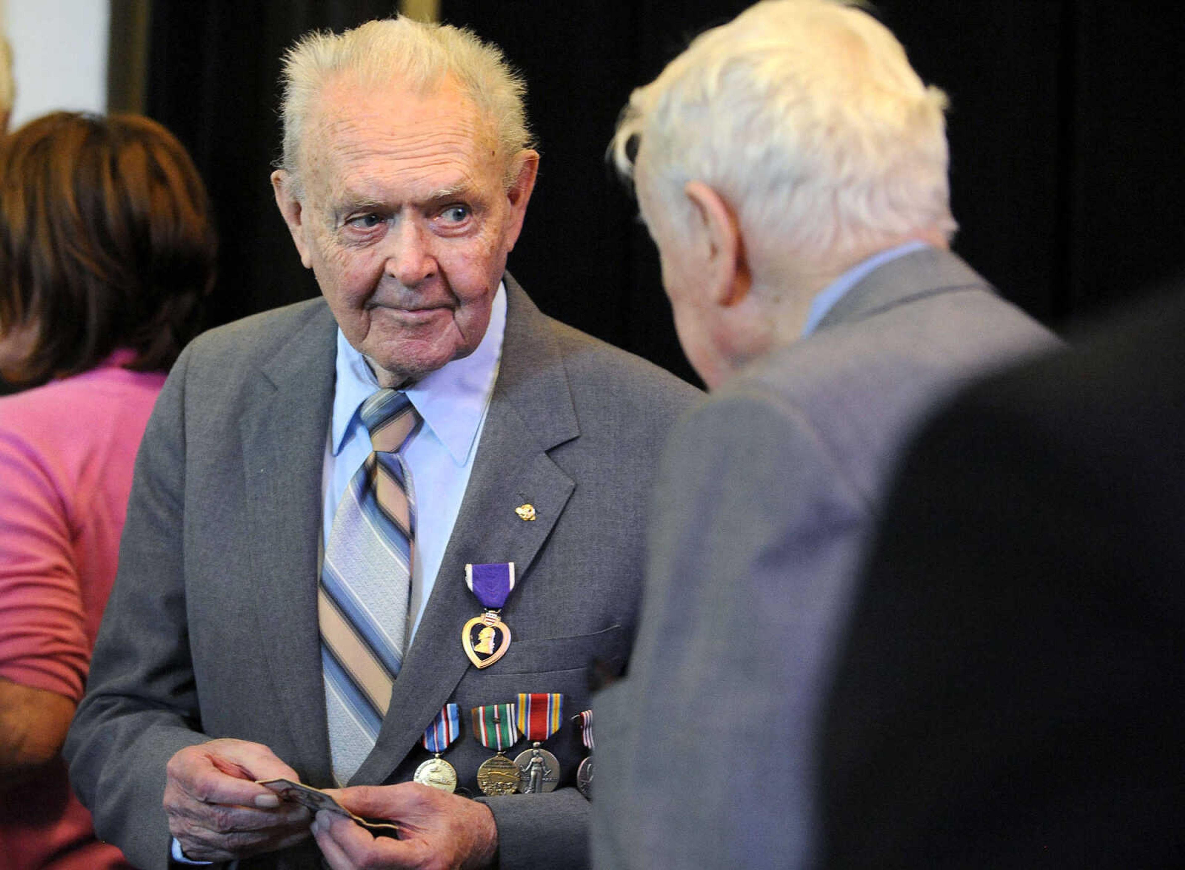 LAURA SIMON ~ lsimon@semissourian.com

Sgt. Clifford Heinrich, left, speaks with James Bass on Monday, March 21, 2016, at the end of the living history event honoring the WWII lost crew of the Flying Fortress 812, and the medal presentation to Sgt. Clifford Heinrich at Alma Schrader Elementary. Heinrich was presented with an American Campaign Medal, WWII Victory Medal, Army Good Conduct Medal, a WWII Lapel Button, European-African-Middle Eastern Campaign Medal and the Purple Heart for his service during WWII during Monday's presentation.