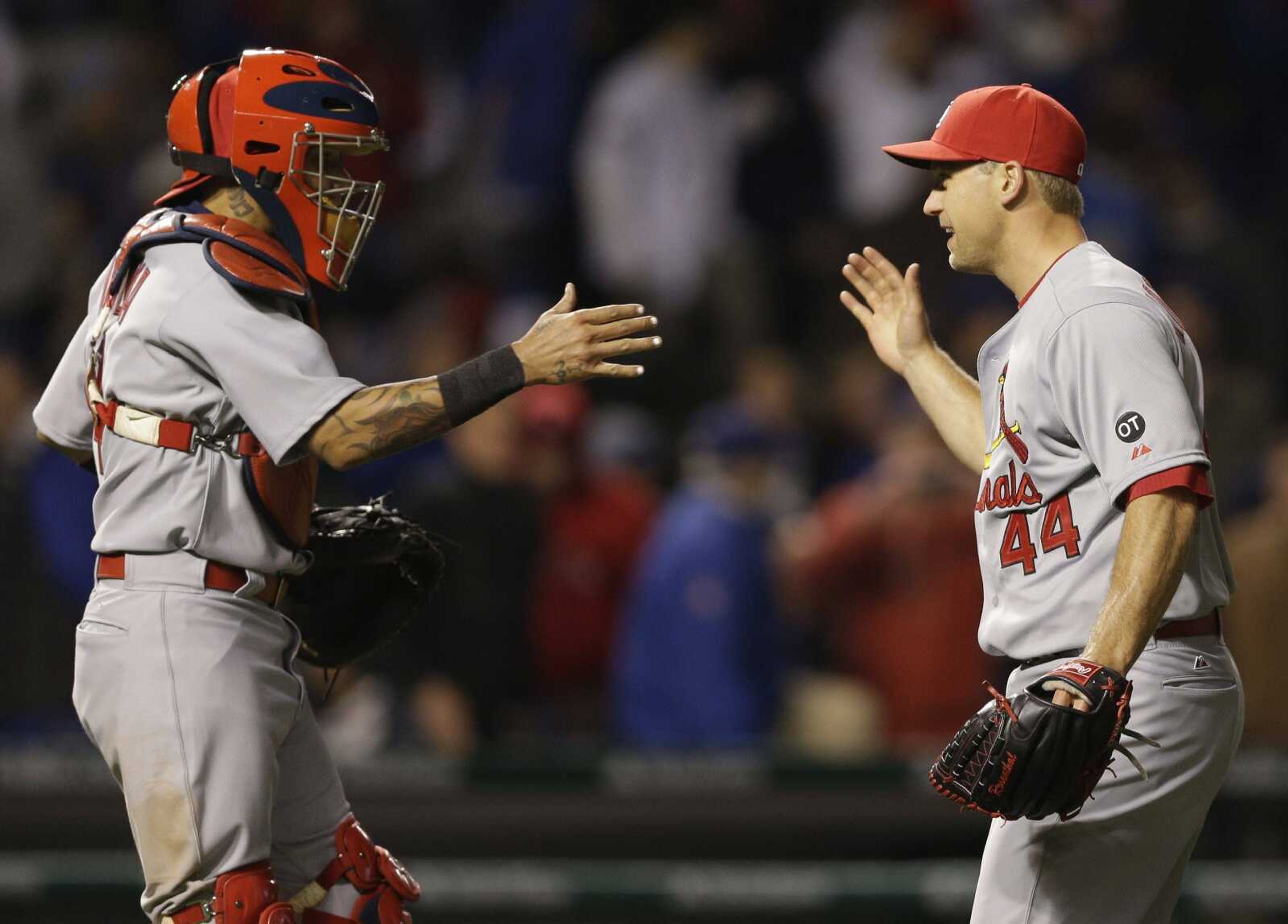 St. Louis Cardinals closer Trevor Rosenthal, right, celebrates with catcher Yadier Molina after the Cardinals defeated the Chicago Cubs 3-0 in a Major League Baseball season-opening game in Chicago, Sunday, April 5, 2015. (AP Photo/Nam Y. Huh)