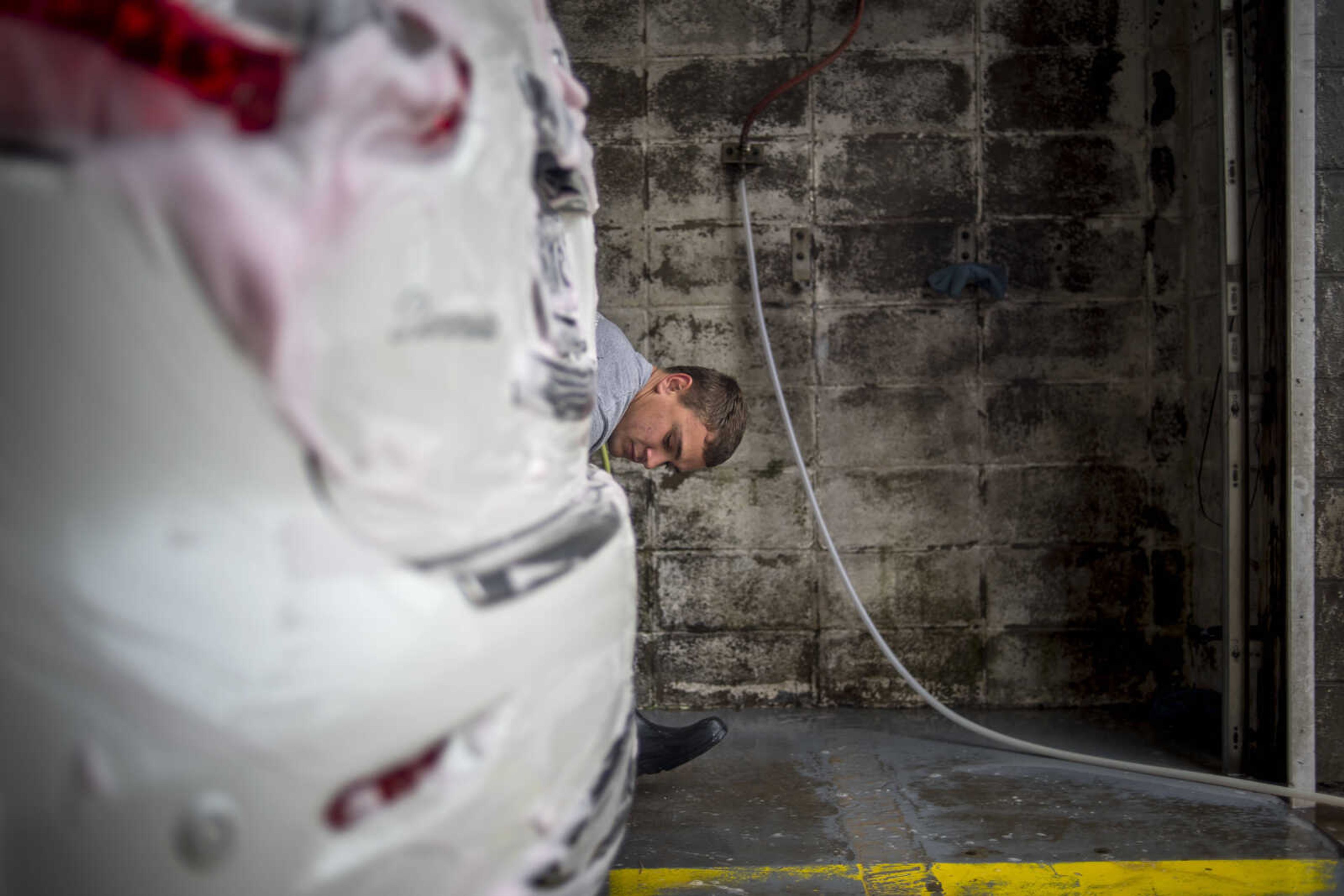 Clayton Golden soaps up a car bumper while working at Teen Challenge Car Wash Express in Cape Girardeau Thursday, Dec. 20, 2018. The car wash will close at year's end for the well-being of the workers, many of whom are in recovery from drug or alcohol addiction. Teen Challenge plans to open another thrift store in Sikeston, Missouri, after the car wash closes in order to provide more work to the students in the program.