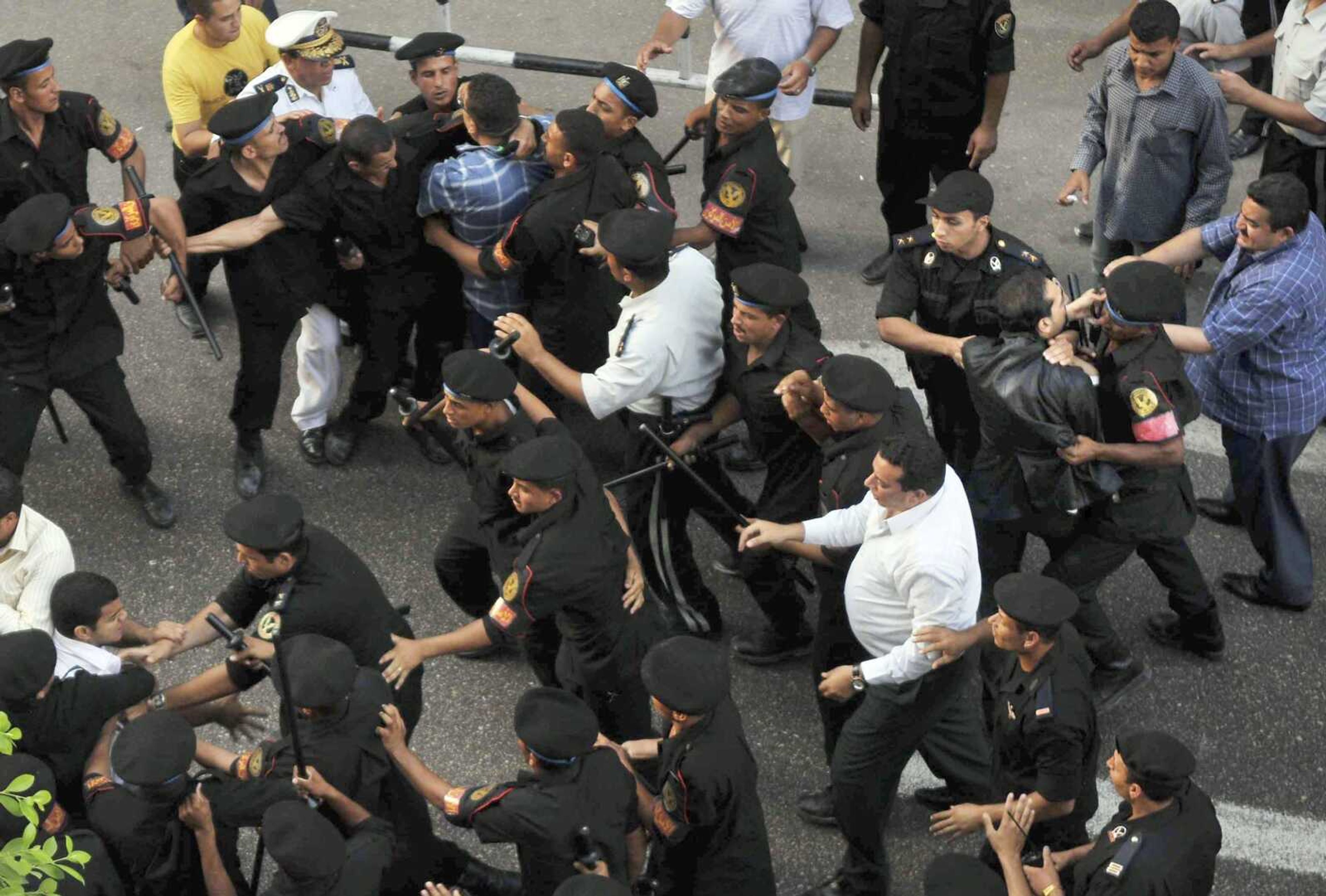 Egyptian anti-riot policemen prevent  demonstrators from gathering at a Cairo downtown street  on Saturday, June 27, 2009, during a protest to commemorate the 7th day of the death of slain Iranian protester Neda Agha Soltan, who was killed by a shot to the chest  during a protest following Iran elections. (AP Photo)