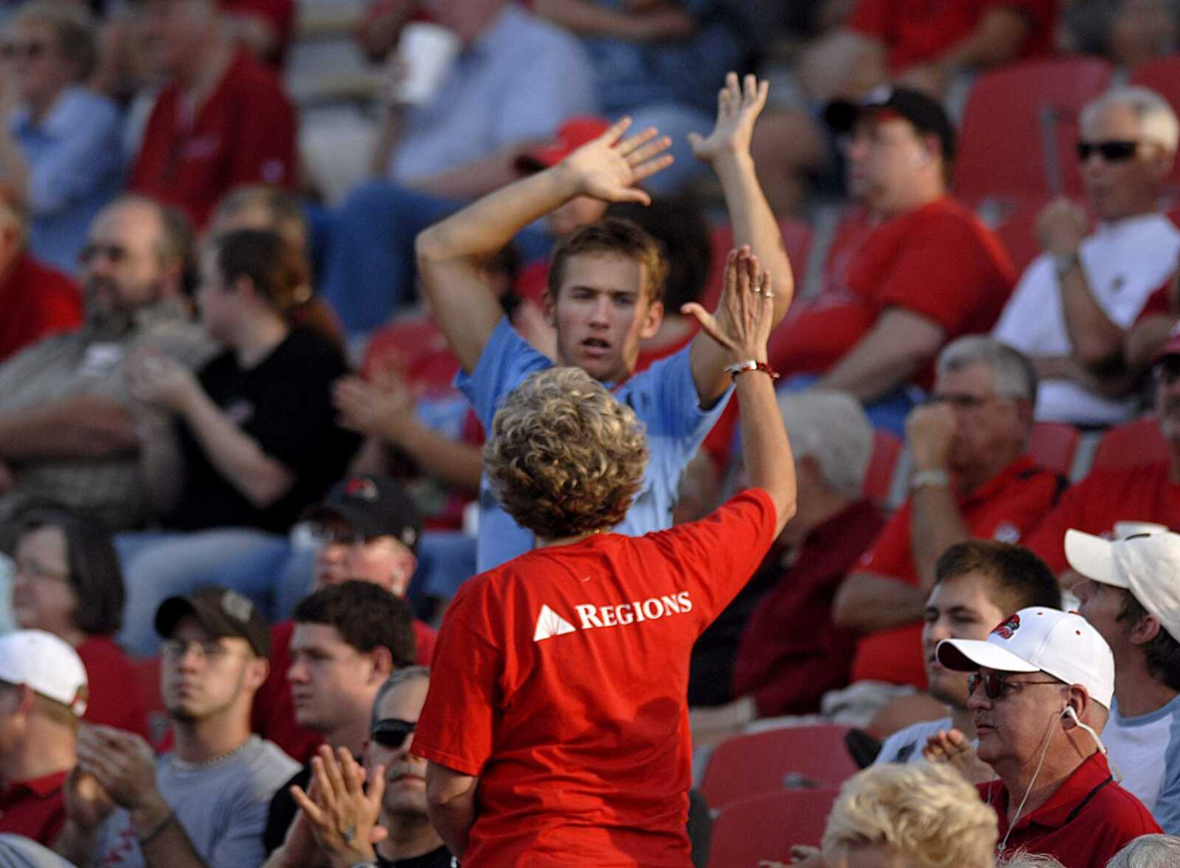 AARON EISEHAUER ~ aeisenhauer@semissourian.com
Two fans give each other high fives following a play by Southeast during their home opener against Southwest Baptist on Thursday, August 28, 2008.