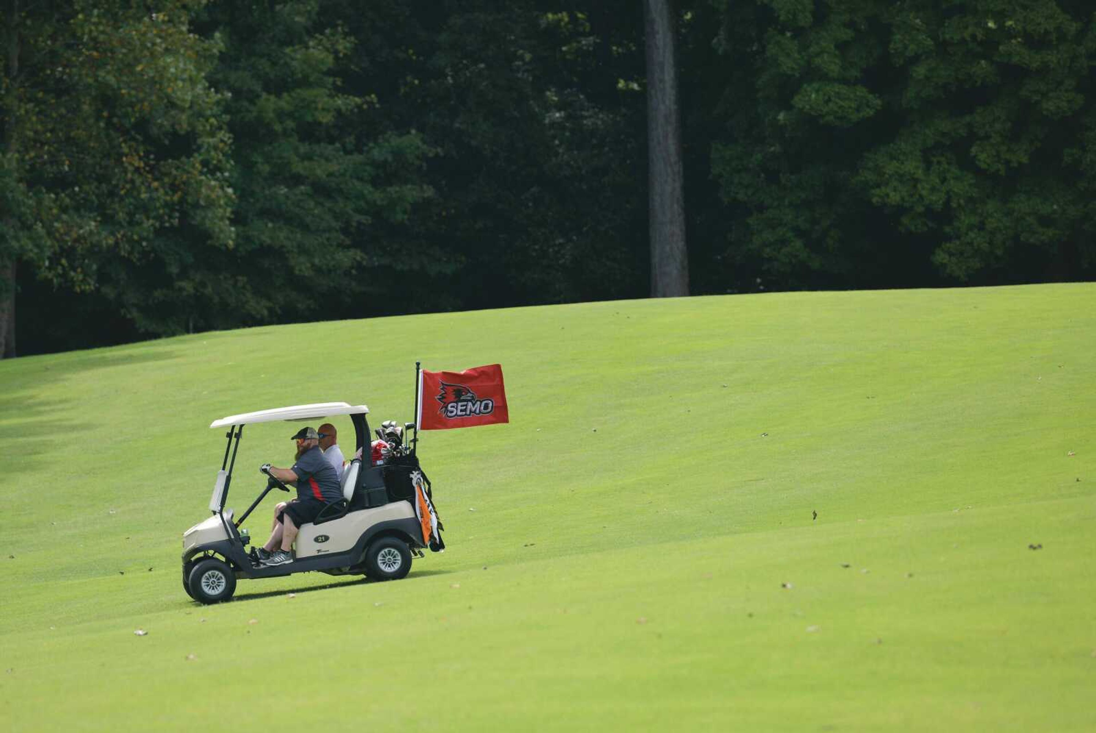 Andy Robert drives a golf cart with a SEMO flag during the 37th Annual Kohlfeld Distributing Charlie Brune Classic that raises money for SEMO student-athlete scholarships at the Cape Girardeau Country Club on Monday, Sept. 14, 2020.