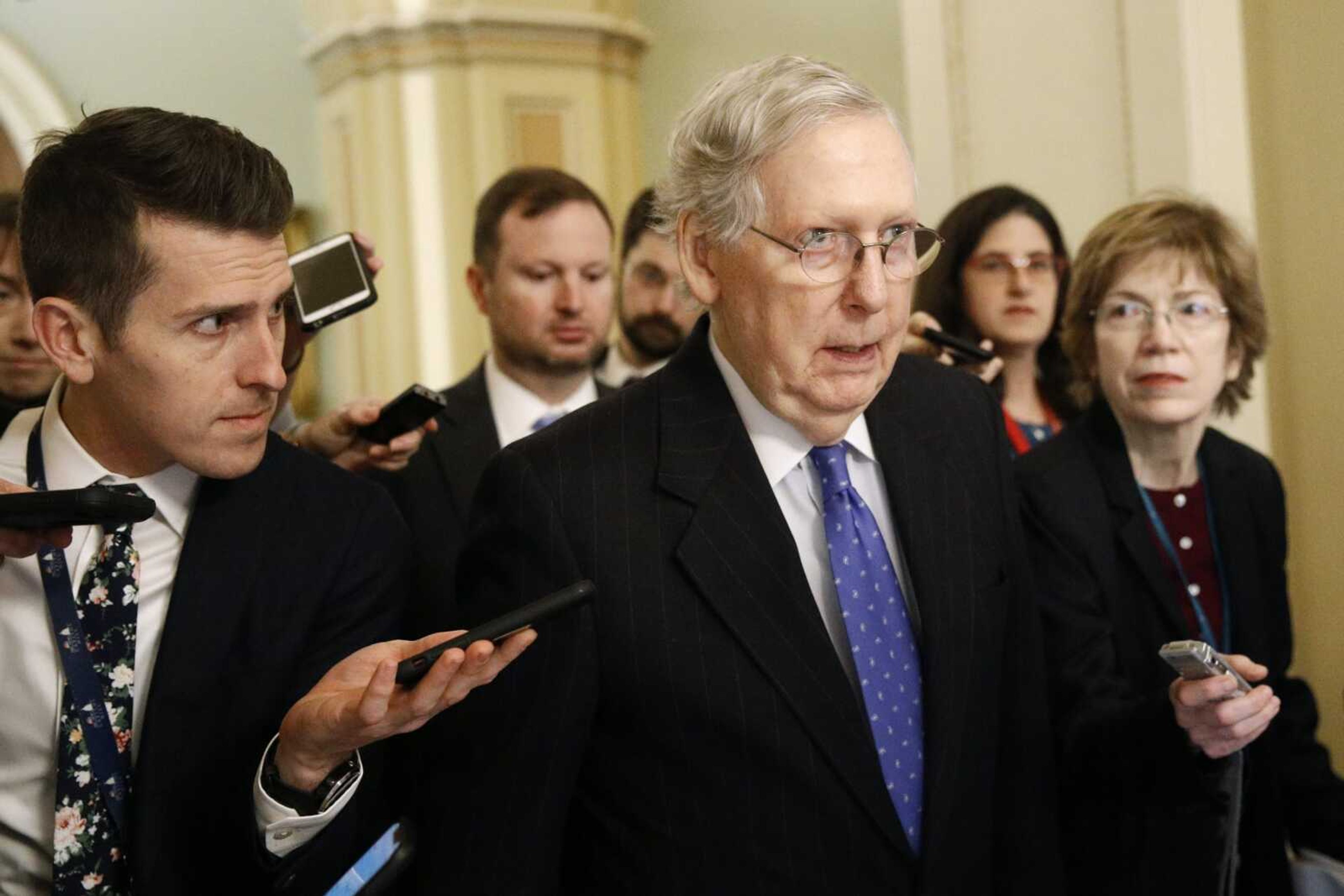 Senate Majority Leader Mitch McConnell speaks with reporters after walking off the Senate floor Thursday on Capitol Hill in Washington.