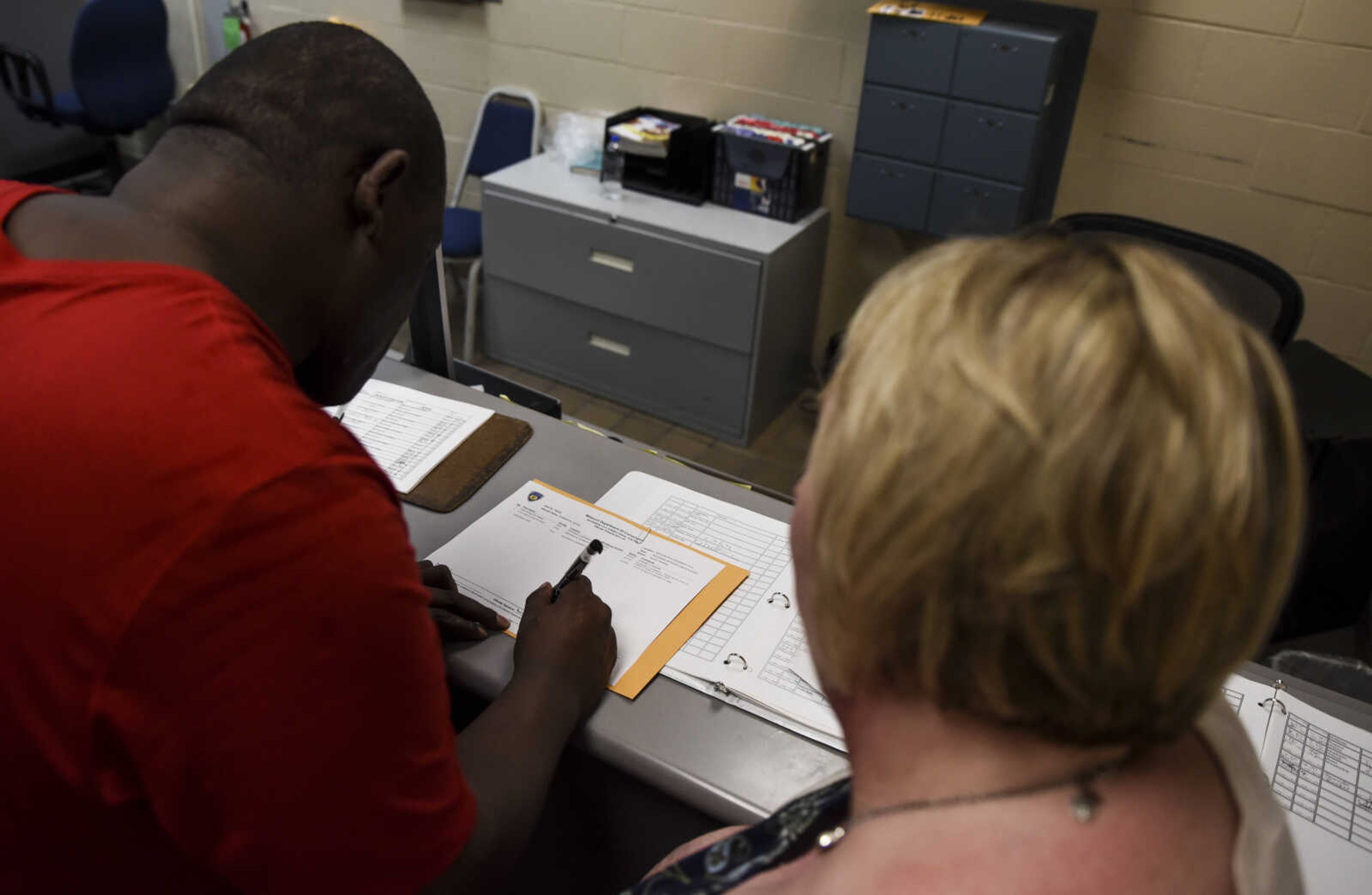 David Robinson signs his final release papers before leaving the Jefferson City Correctional facility Monday, May 14, 2018 in Jefferson City.