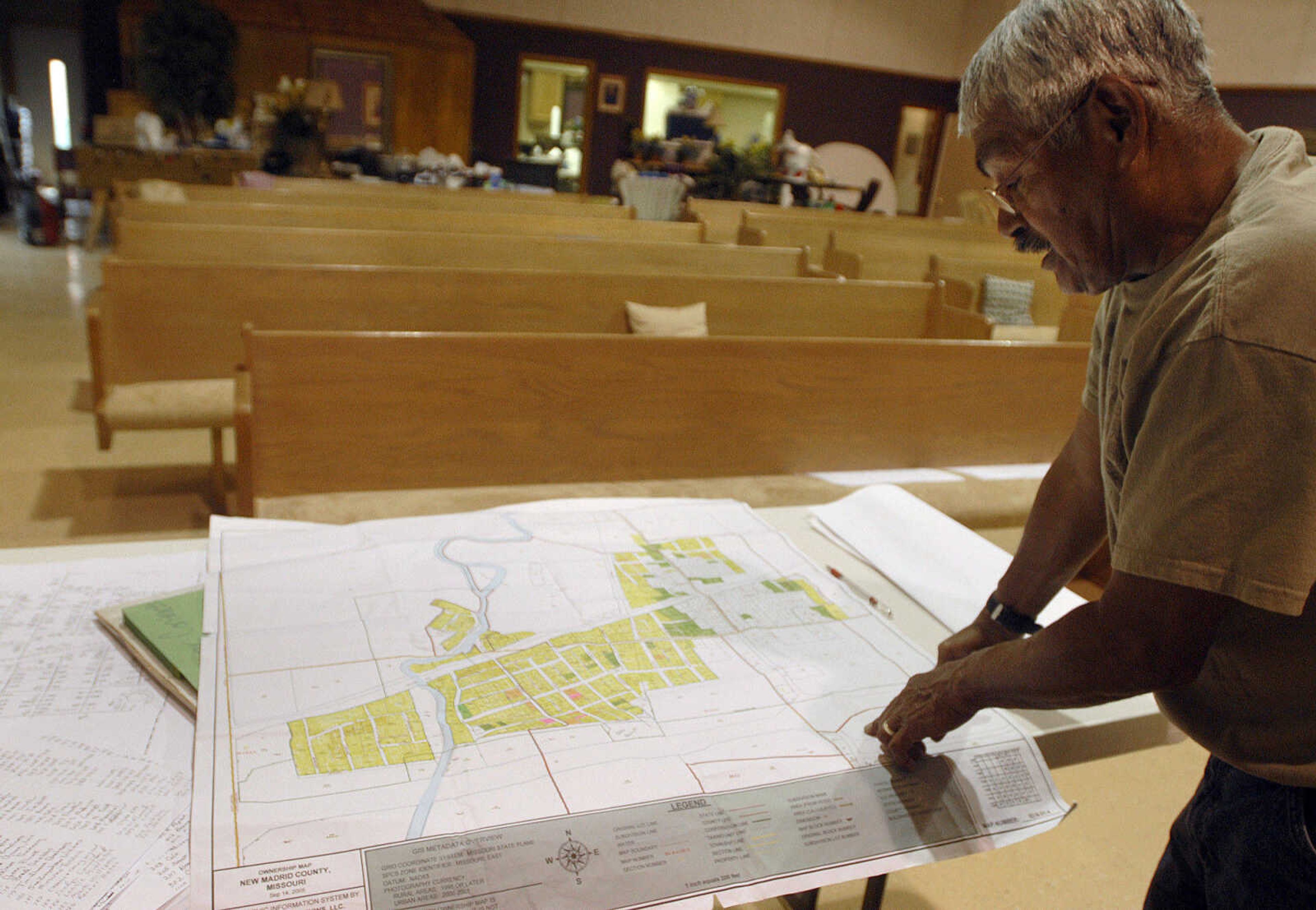 LAURA SIMON~lsimon@semissourian.com
Morehouse Mayor Pete Leija looks over a map of his town inside the First General Baptist Church gymnasium Wednesday, May 11, 2011 in Morehouse.