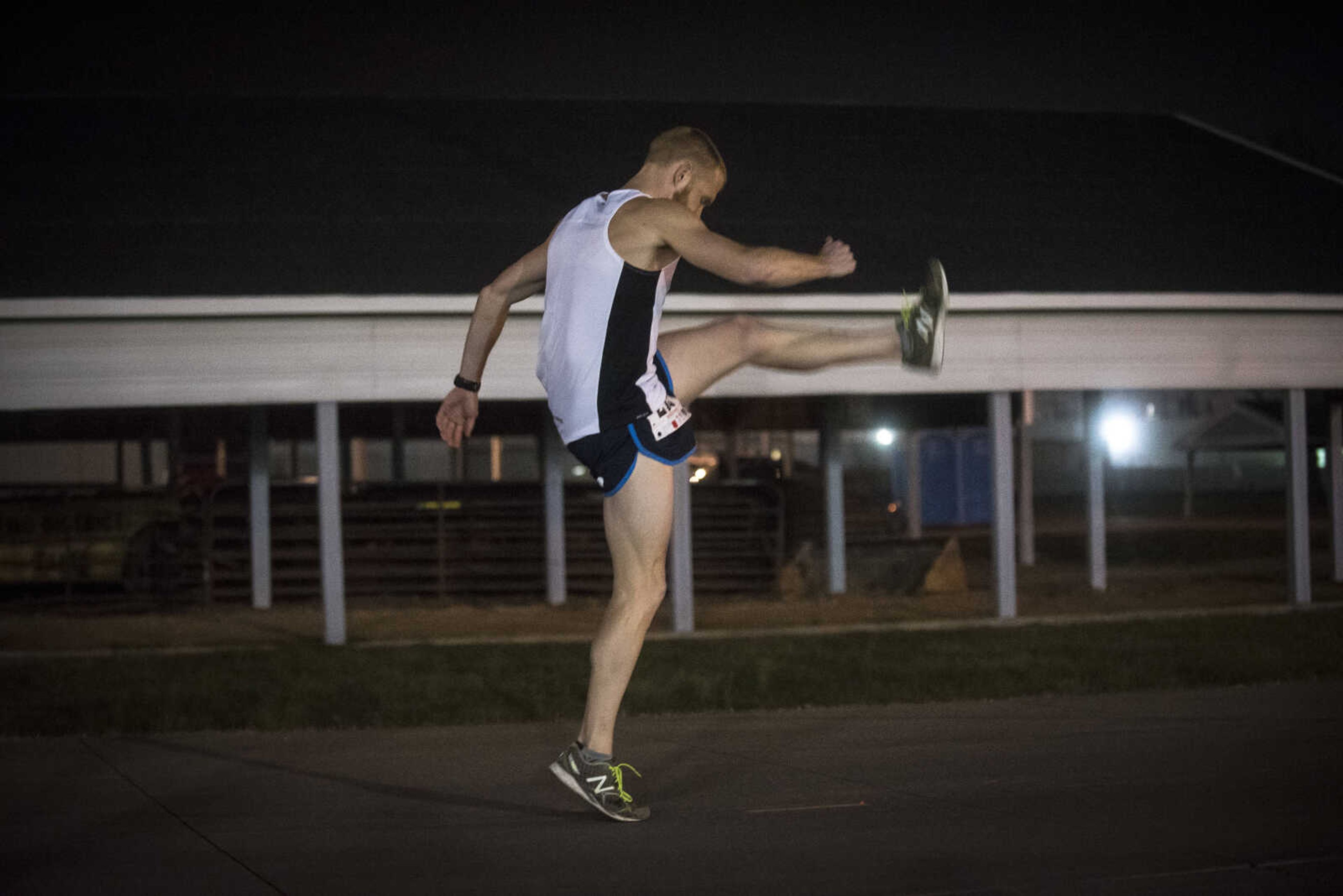 Matt Pfau warms up before running in the midnight 5k for the 8th annual Howard Aslinger Endurance Run on Saturday, March 18, 2017 in Cape Girardeau.