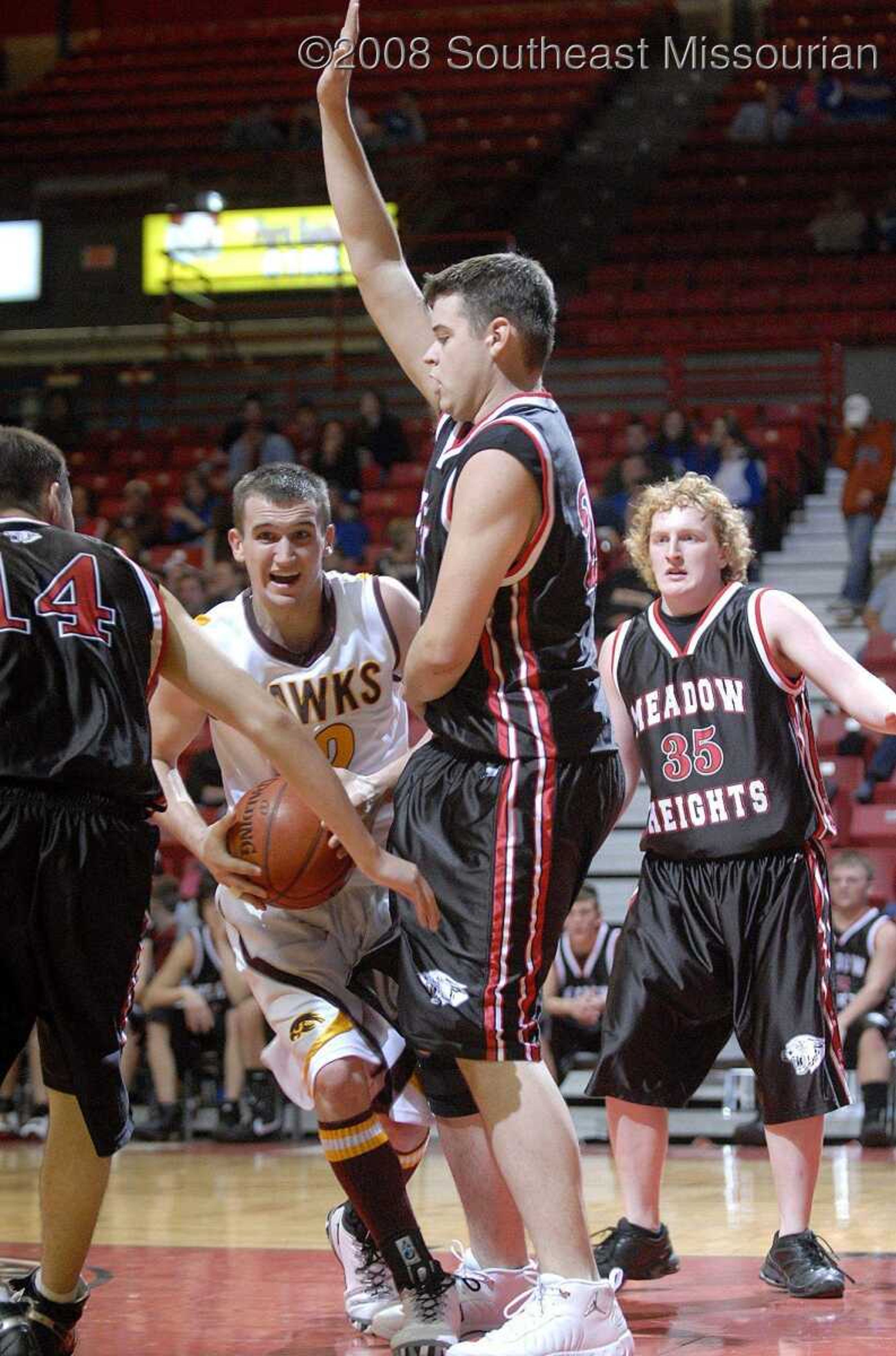 ELIZABETH DODD ~ edodd@semissourian.com
Kelly's Josh DeBrock, left, attempts to dribble around Meadow Heights' Luke Nitsch in the first half of the Christmas Tournament Friday at the Show Me Center. Kelly defeated Meadow Heights 78-61.