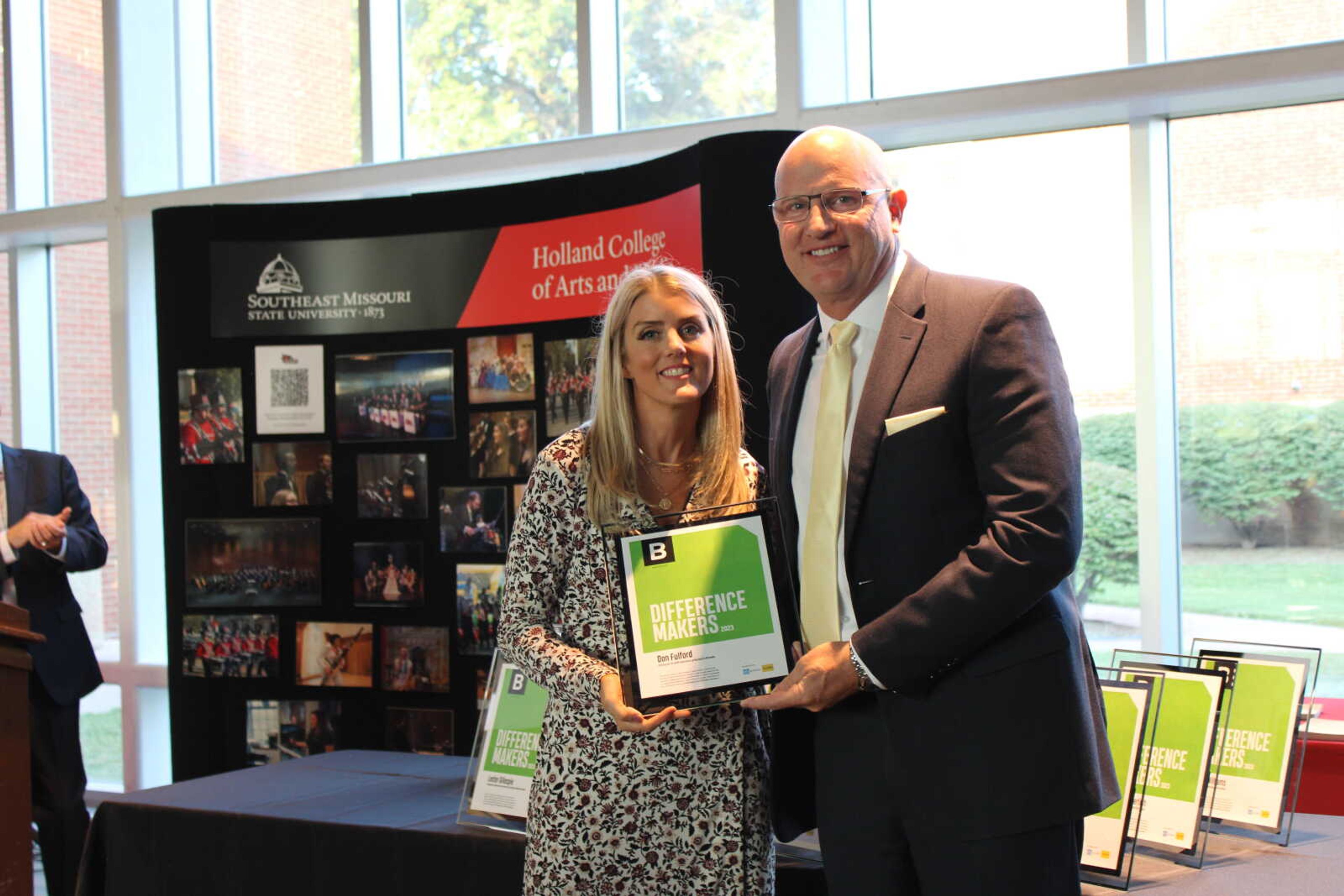 Edward Jones financial advisor Brooke Roth hands Difference Maker Don Fulford his award.