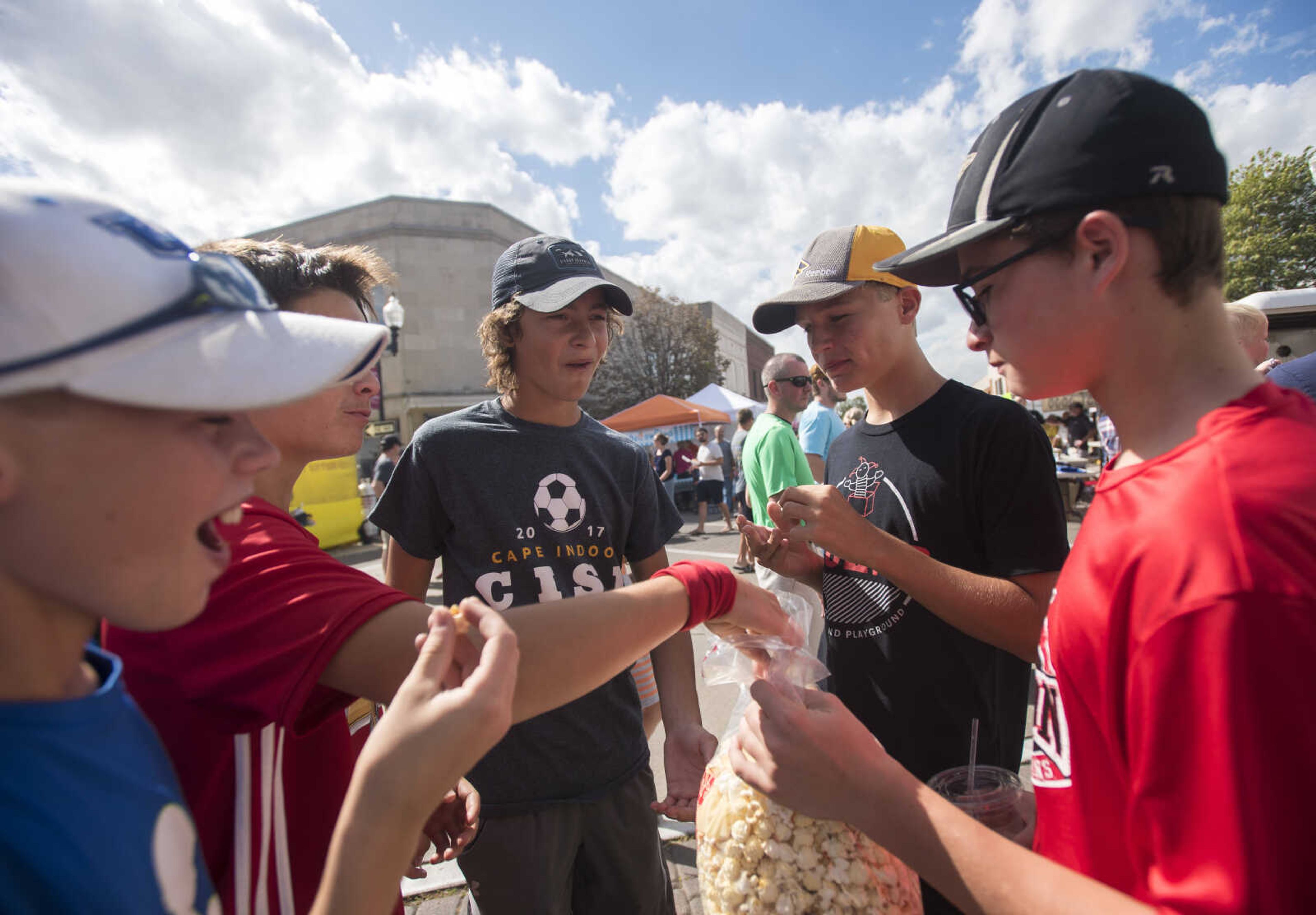 From left, Nolan Dry, Drew Nugent, Cooper Pettit, Grant Loenneke and Ryley Styer eat kettle corn at the Uptown Jackson Oktoberfest, Saturday, October 7, 2017.