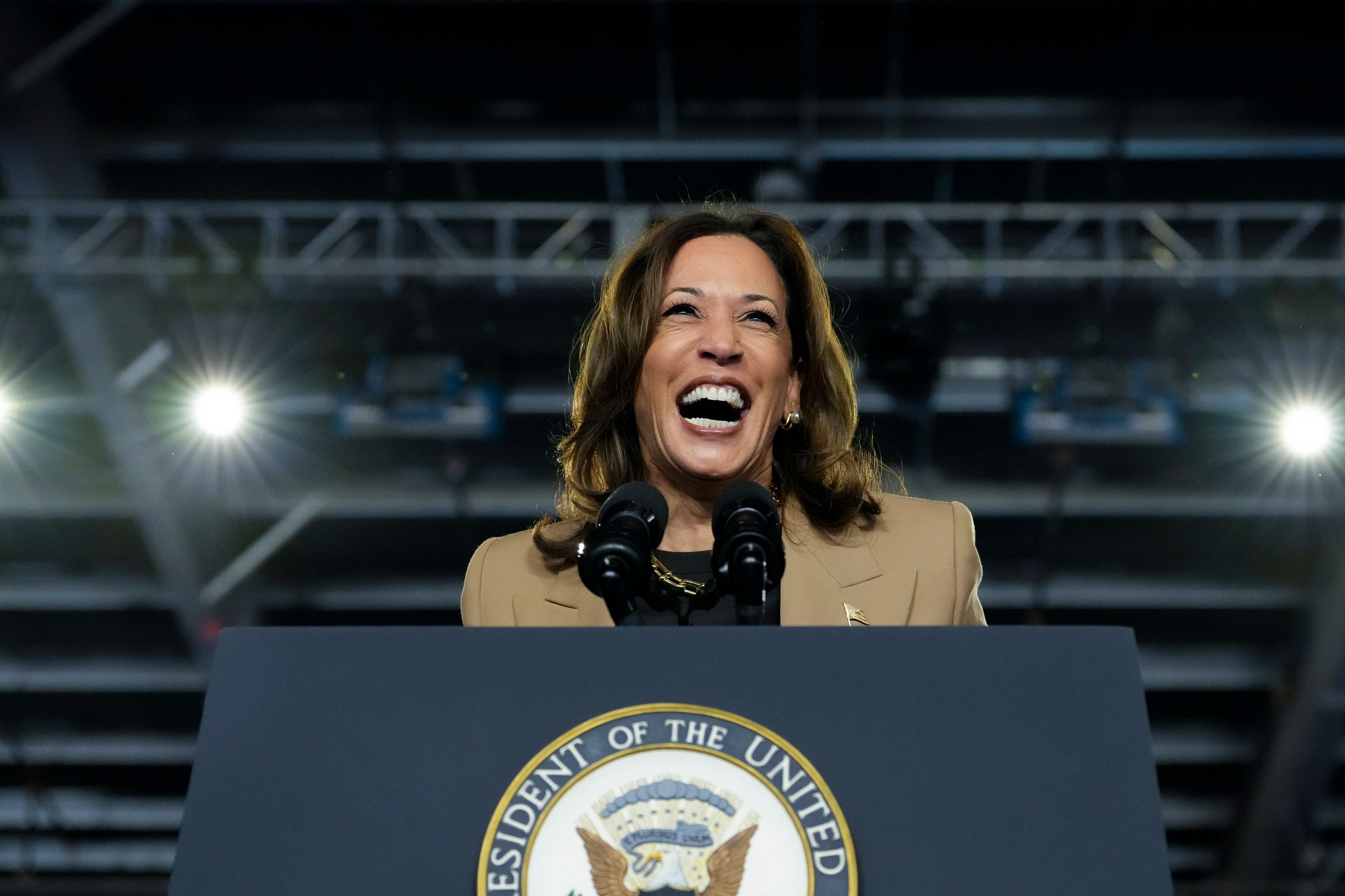 Democratic presidential nominee Vice President Kamala Harris laughs while speaking at a campaign rally Thursday, Oct. 10, 2024, on the Gila River Indian Community reservation in Chandler, Ariz. (AP Photo/Ross D. Franklin)