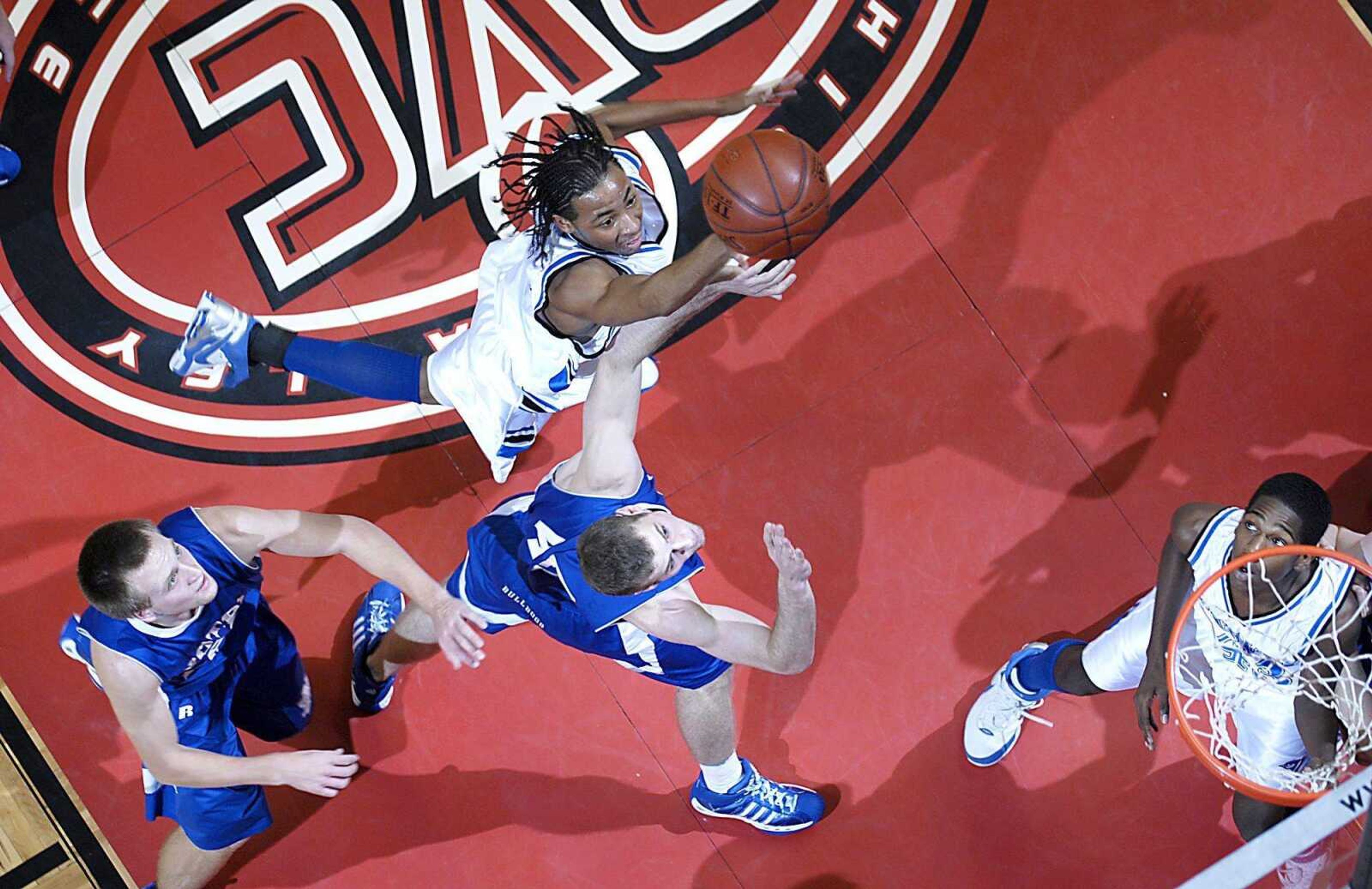 Charleston junior Donald Dixon, top, shot over Notre Dame defenders during their semifinal game Friday night at the Show Me Center. Notre Dame won 70-67. (Kit Doyle)