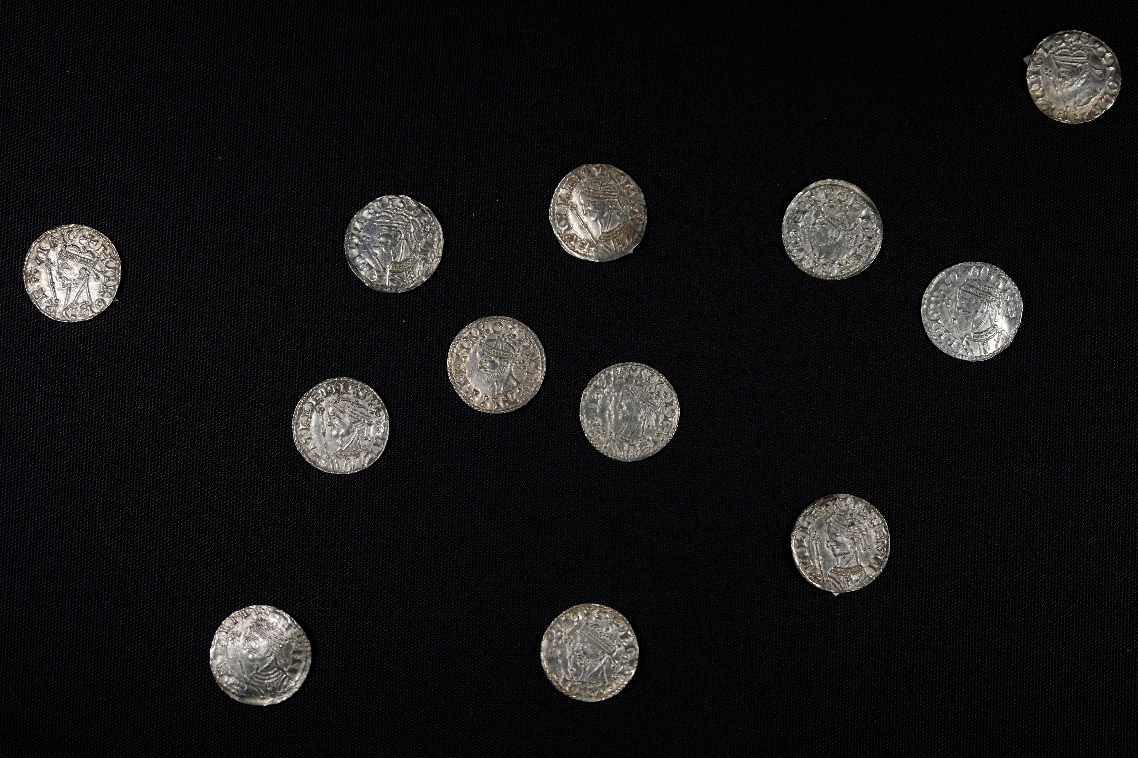 A selection of coins dating from the time around the Norman Invasion of Britain in 1066, which are part of the Chew Valley Hoard of 2,584 coins, on display at the British Museum in London, Tuesday, Oct. 22, 2024, the hoard is valued at £4.3 million pounds, (US$5.58 million), a record find. (AP Photo/Alastair Grant)