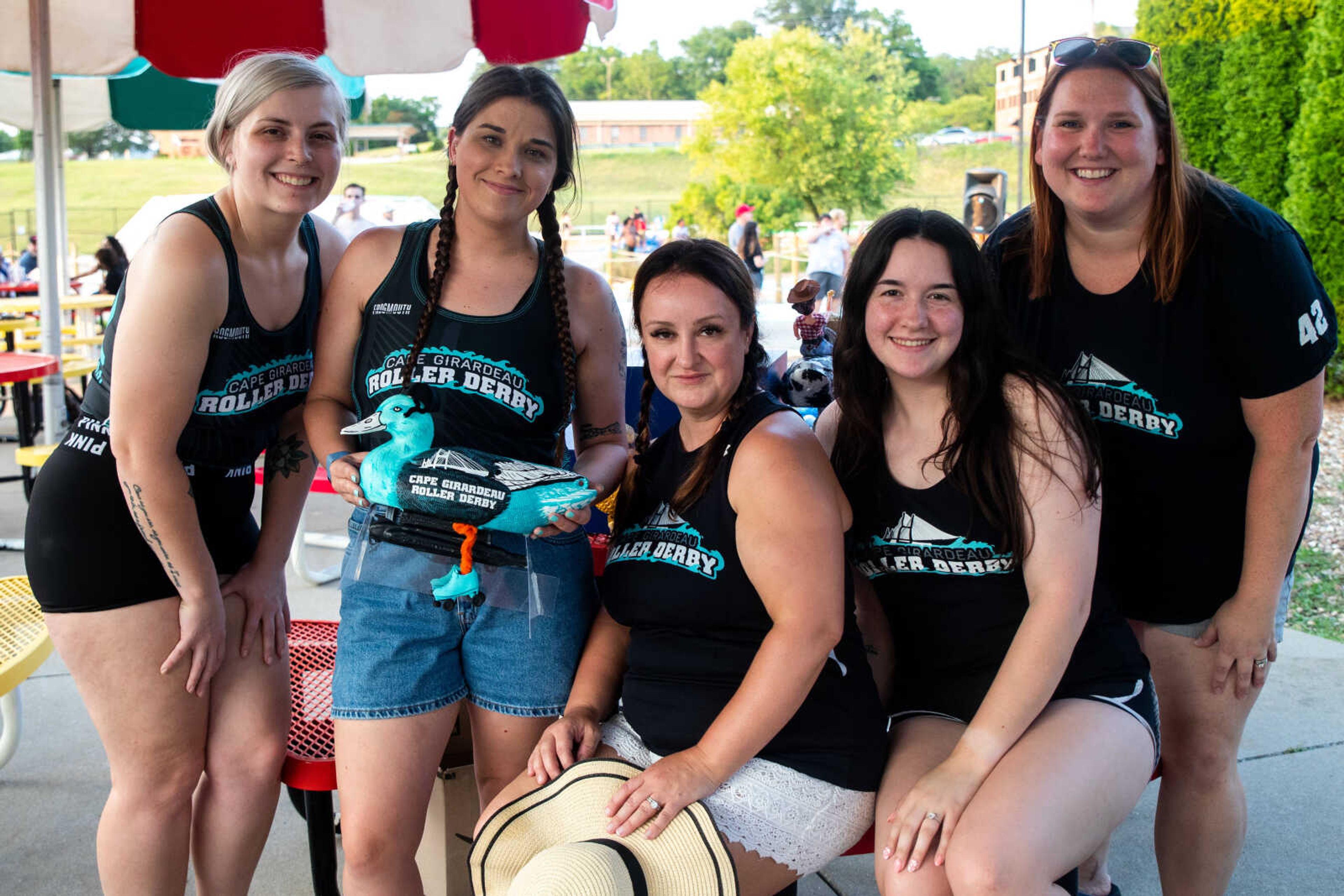 Hannah Elledge, left, Bri DeWitt, Kristin Rickman, Dana Niswonger and Megan Sayers, members of the Cape Girardeau Roller Derby Team, pose for a picture with their duck before the Duck Regatta on&nbsp;Saturday, July 15 at Cape Splash.