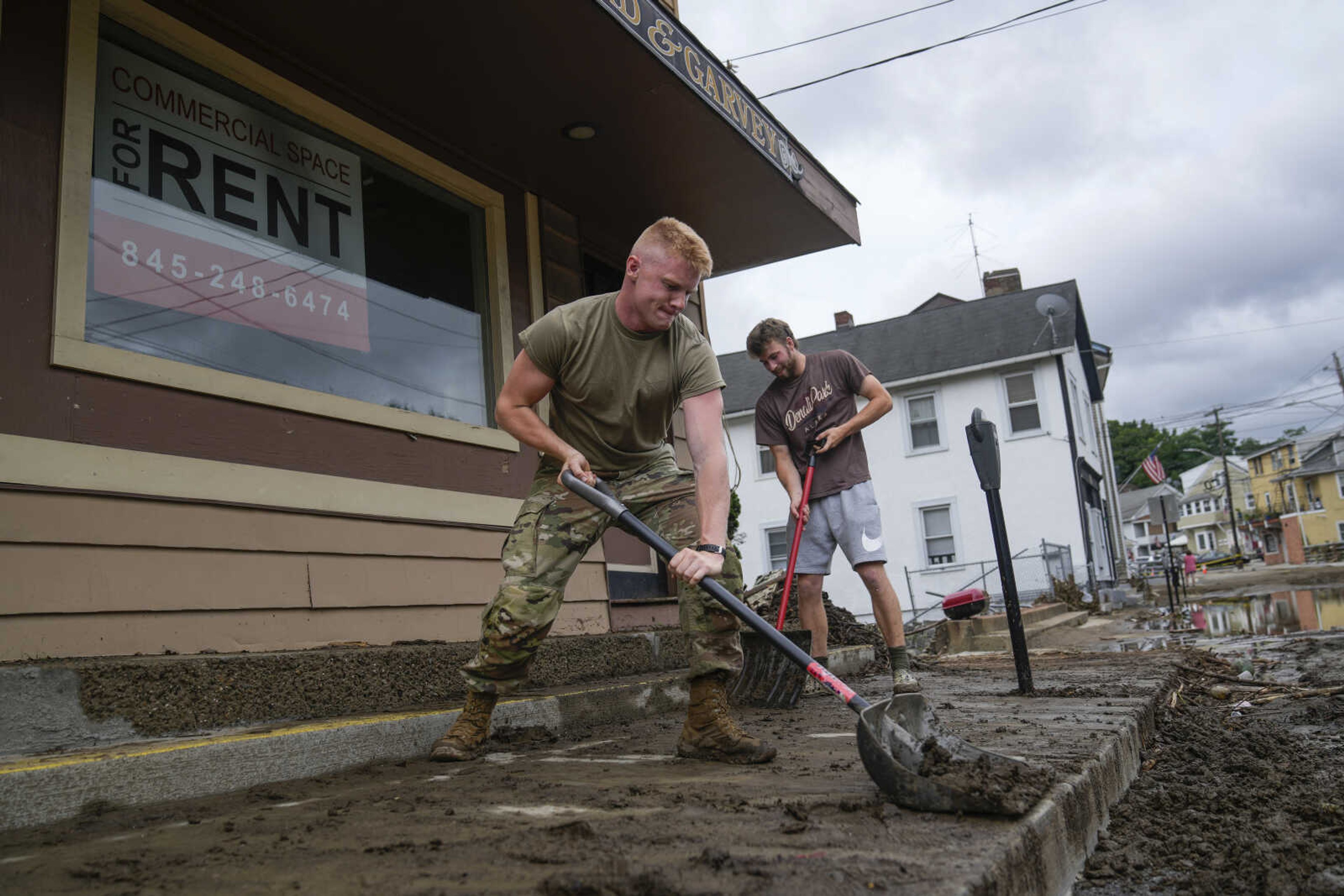 Volunteers help clear Main Street of debris after floodwaters subsided Monday in Highland Falls, New York. Heavy rain has washed out roads and forced evacuations in the Northeast as more downpours were forecast throughout the day. One person in New York's Hudson Valley has drowned as she was trying to leave her home.