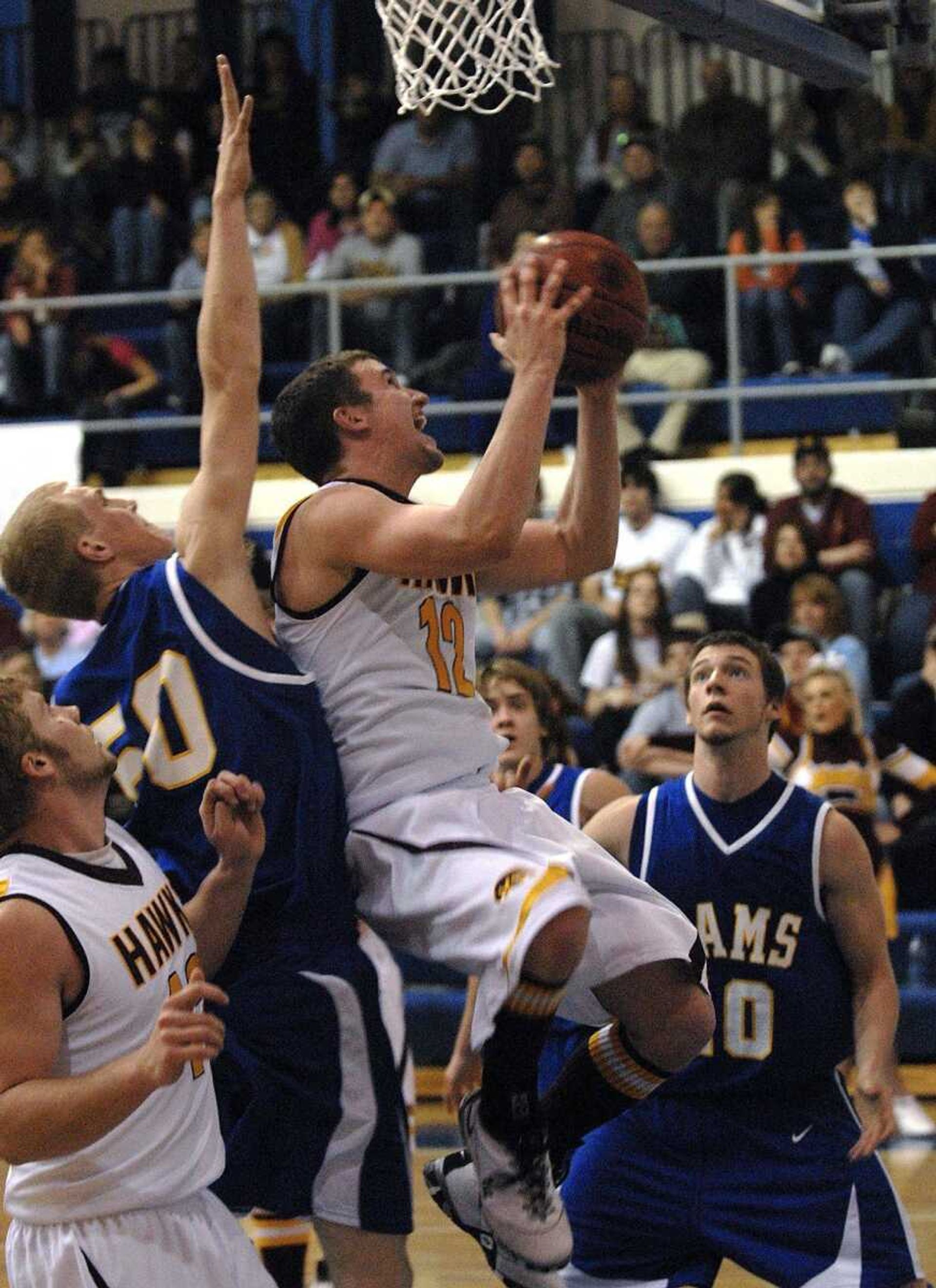 FRED LYNCH ~ flynch@semissourian.com
Kelly's Josh DeBrock goes up for a shot between Scott City's Jonathan Lacey and Cody Page during the third quarter of their first-round Class 3 District 1 game Monday at Charleston.