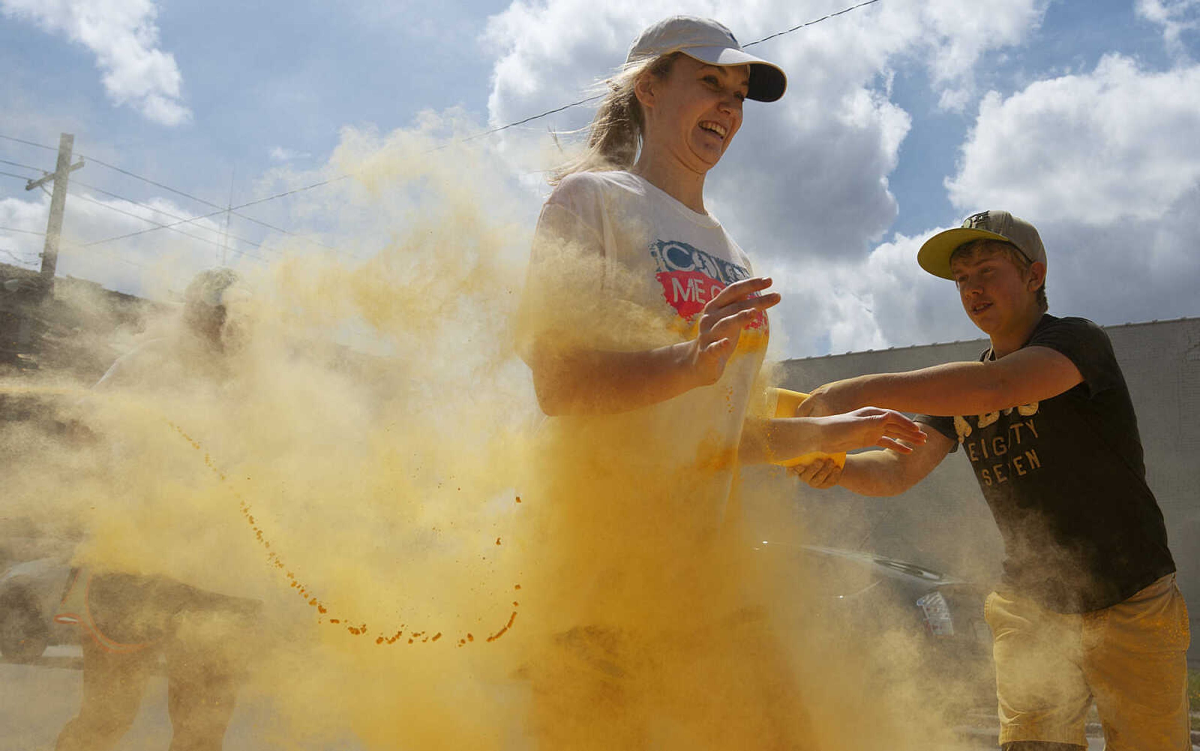 ADAM VOGLER ~ avogler@semissourian.com
Participants in the Color Me Cape 5k run through the yellow color station north of the intersection of Independence Street and Frederick Street Saturday, April 12, in Cape Girardeau.