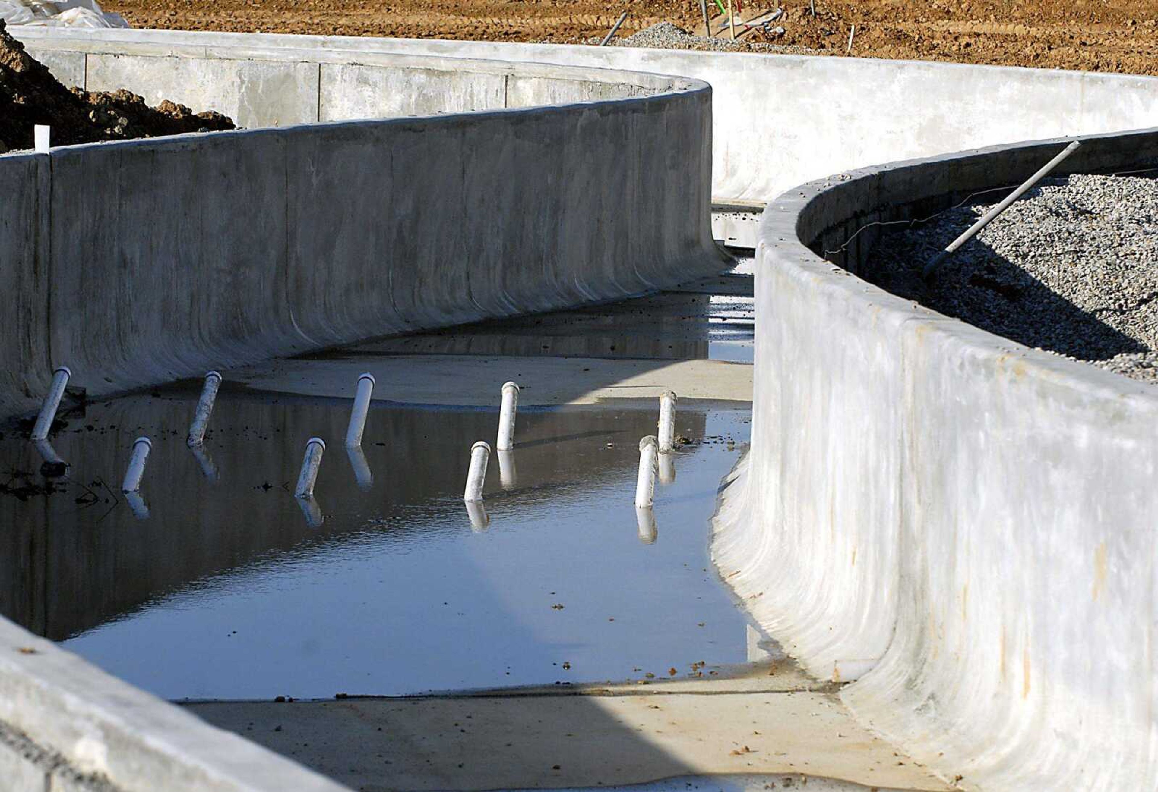 Pipes that will provide the water propulsion stick out of the empty lazy river Monday while work continues at the Family Aquatic Center in Osage Park in Cape Girardeau.