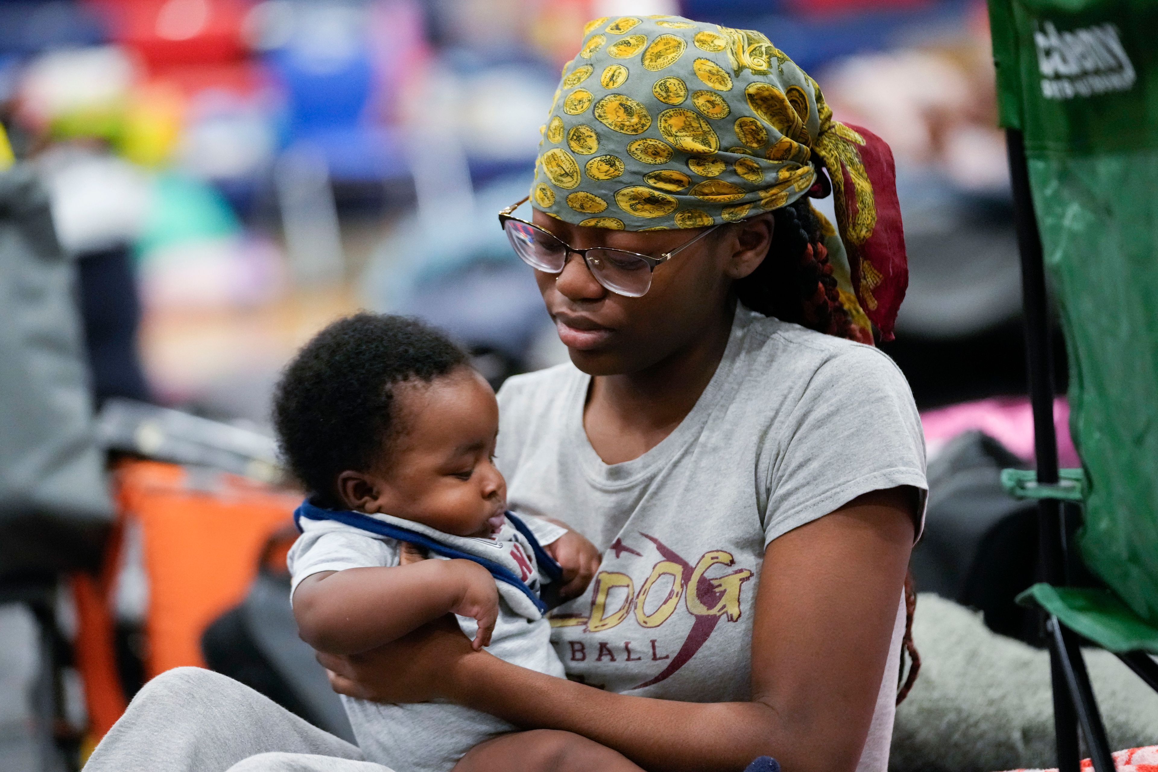 Katoria Harvey, of Tallahassee, sits with her niece Ny'Year Harvey, 3 months, inside a hurricane evacuation shelter at Fairview Middle School, ahead of Hurricane Helene, expected to make landfall here today, in Leon County, Fla., Thursday, Sept. 26, 2024. (AP Photo/Gerald Herbert)