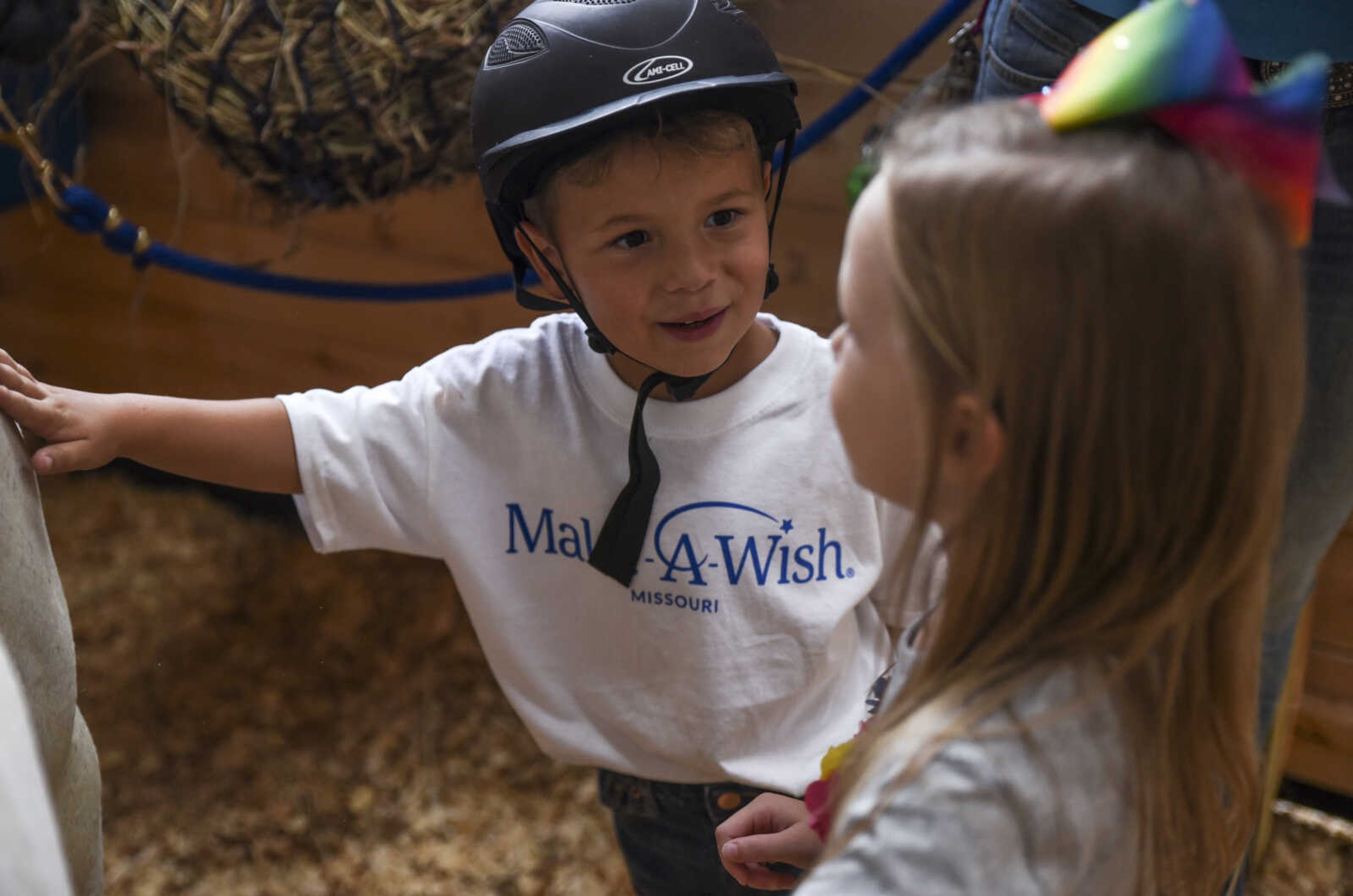 Nate Prichard, 5, shows his cousin Jocelyn Warren, 5, his new horse Silver Monday, July 30, 2018 in&nbsp;Burfordville.