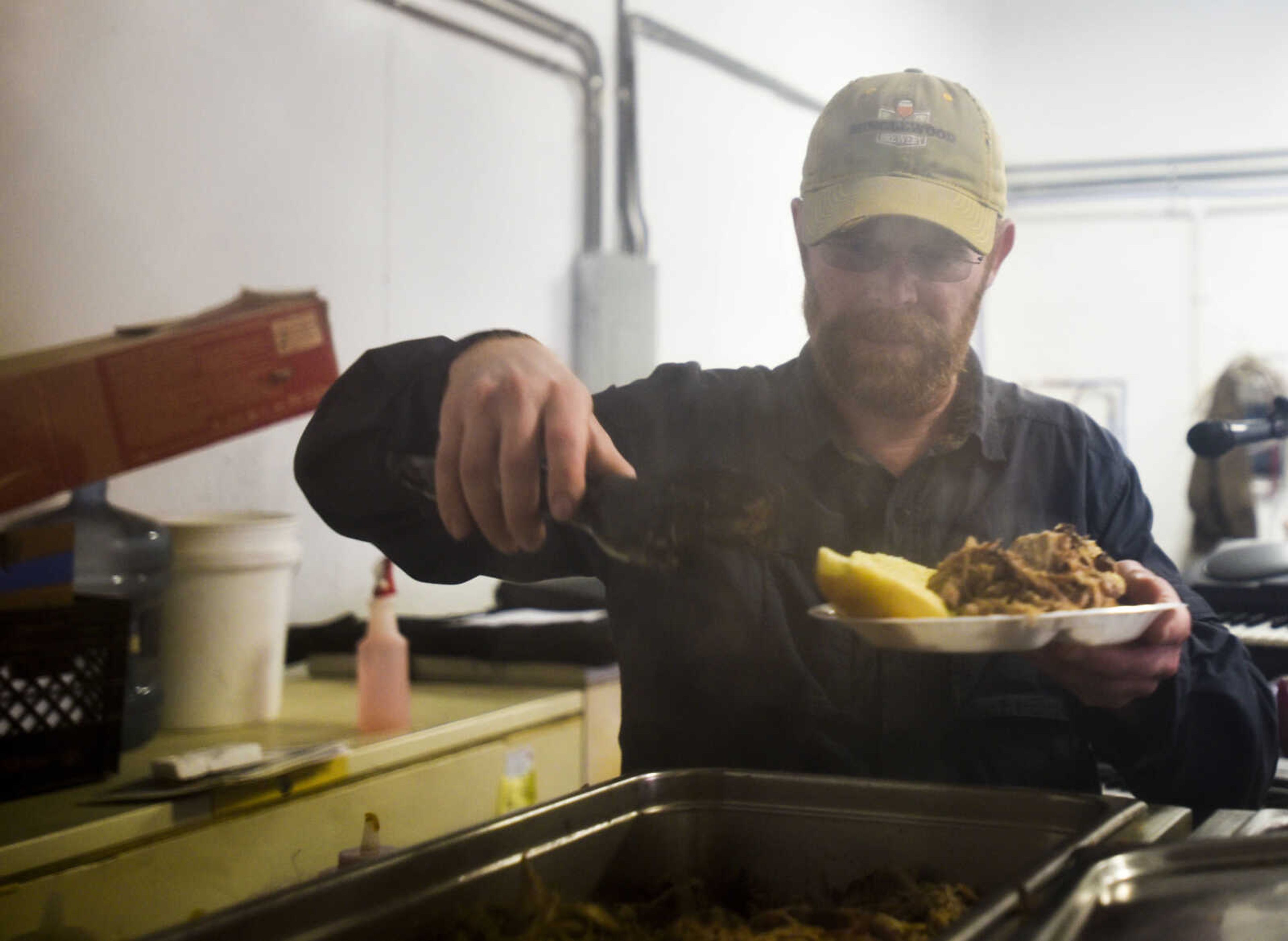 Minglewood Brewery owner Stuart Matthews fixes a plate at the 9th annual Brew Movement Against Multiple Sclerosis held Saturday, March 24, 2018, in Jackson.