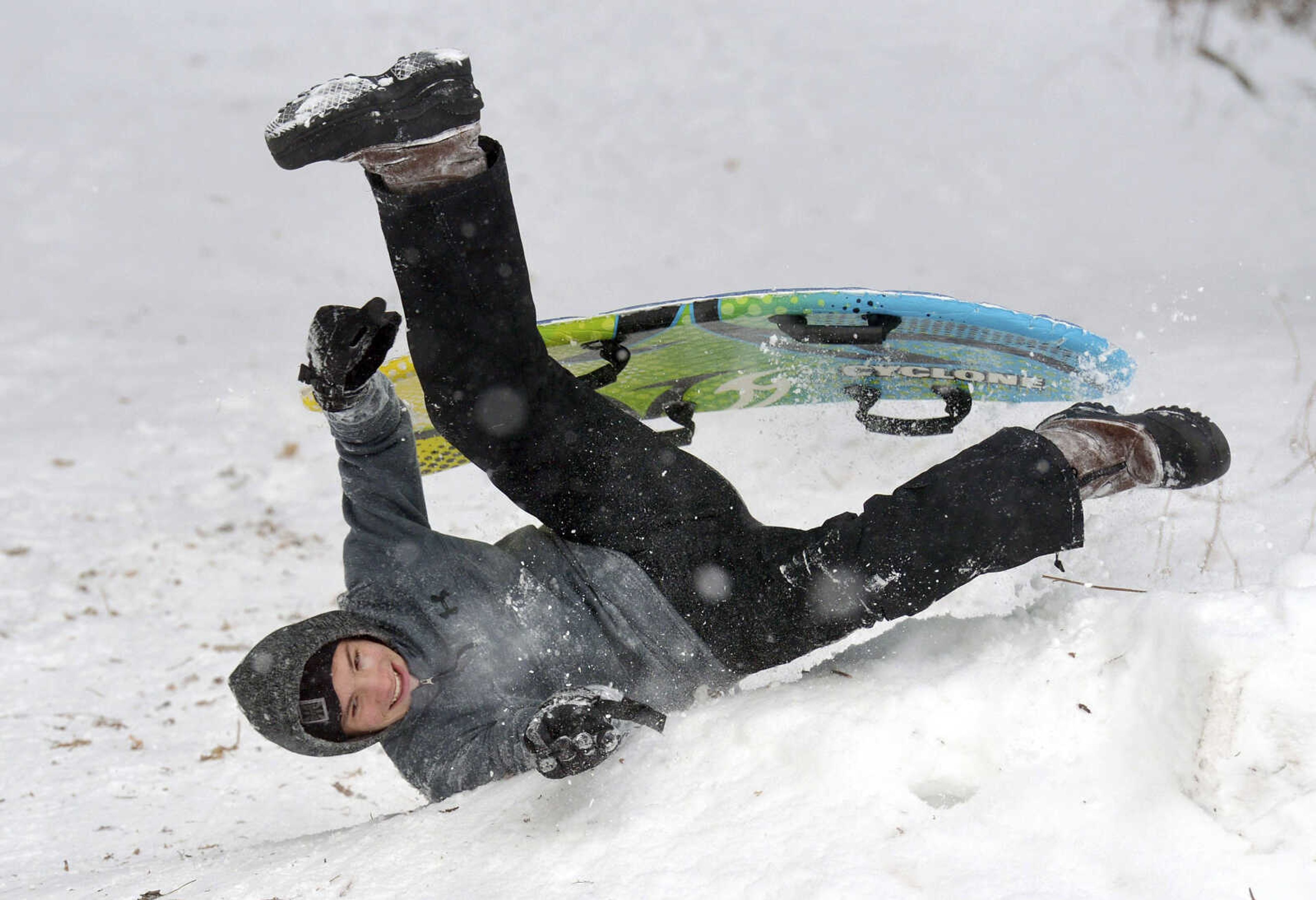 Aiden Cook, 12, of Atlanta flies off his sled as he heads down a hill Tuesday at Kiwanis Park in St. Joseph, Michigan.