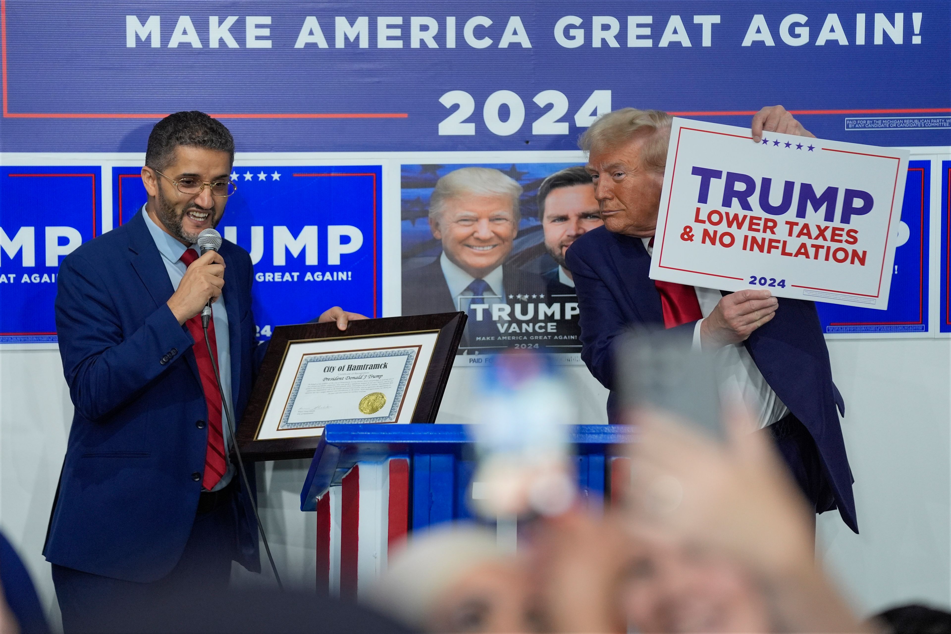 Hamtramck Mayor Amer Ghalib speaks as Republican presidential nominee former President Donald Trump listens at a campaign office, Friday, Oct. 18, 2024, in Hamtramck, Mich. (AP Photo/Evan Vucci)