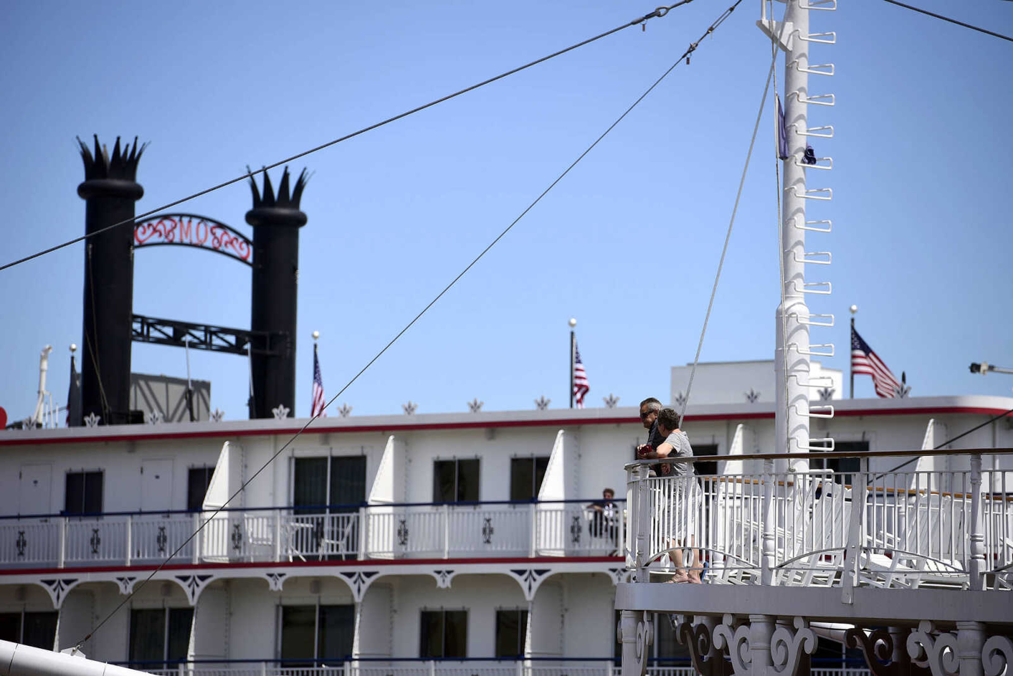 Passengers on the American Queen look out at the Queen of the Mississippi on Wednesday, Aug. 23, 2017, in downtown Cape Girardeau.