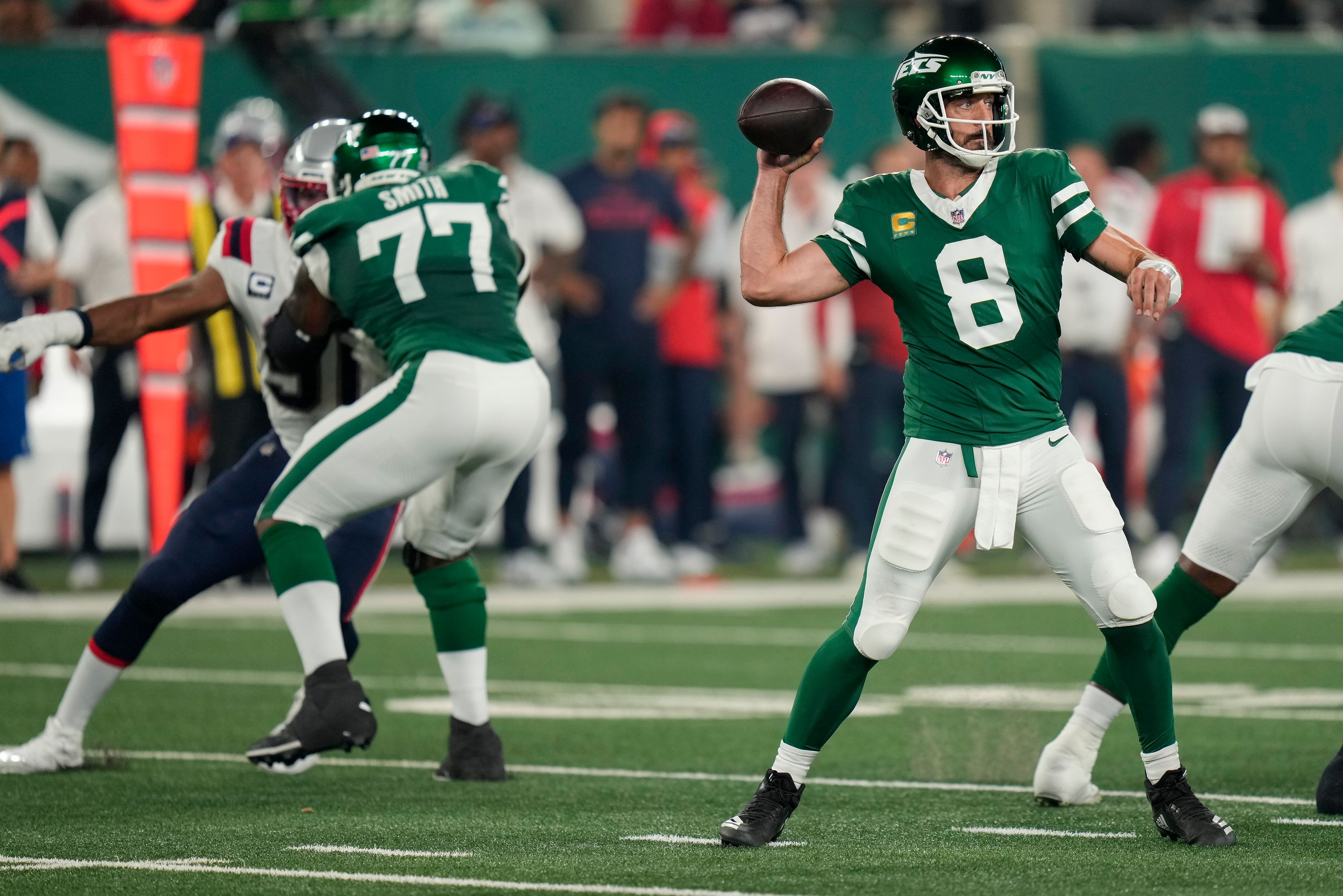 New York Jets quarterback Aaron Rodgers (8) passes against the New England Patriots during the first quarter of an NFL football game, Thursday, Sept. 19, 2024, in East Rutherford, N.J. (AP Photo/Seth Wenig)