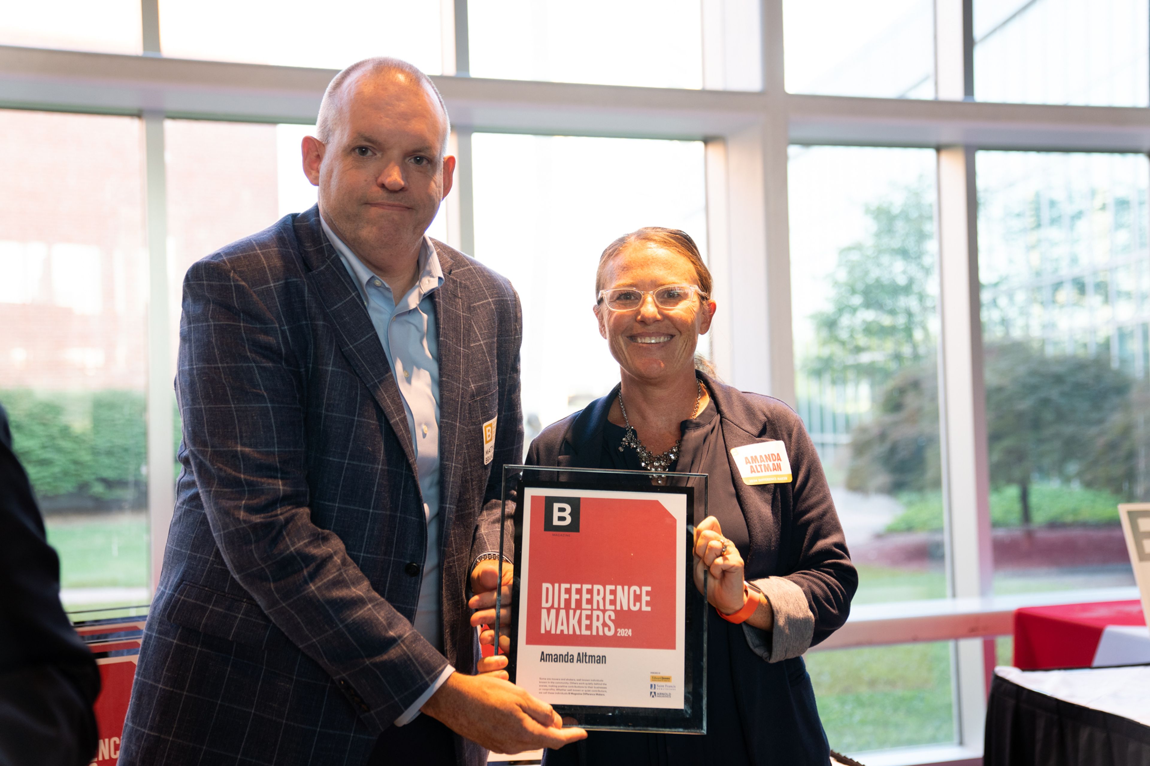 Amanda Altman receives a plaque from Saint Francis Healthcare System’s Matthew Brandt recognizing her as a 2024 Difference Maker at their reception at Southeast Missouri State University’s River Campus. The Difference Maker’s reception was presented by B Magazine on Thursday, Sept. 6.