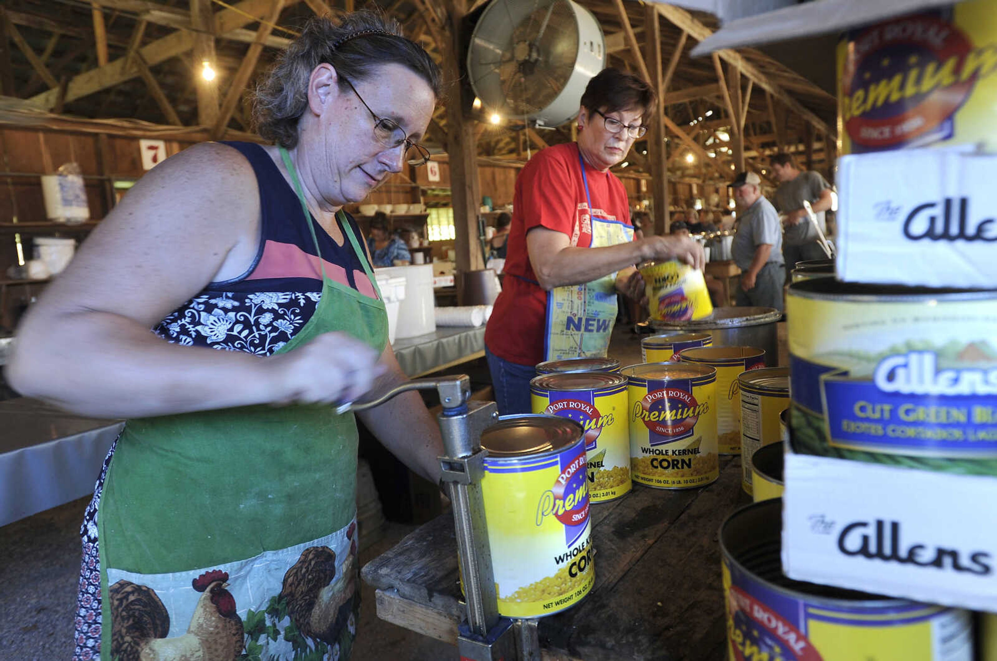 FRED LYNCH ~ flynch@semissourian.com
Diana Horn, left, and Marian Hutchings open cans of corn on Saturday, July 29, 2017 at the St. John's Church Picnic in Leopold, Missouri.