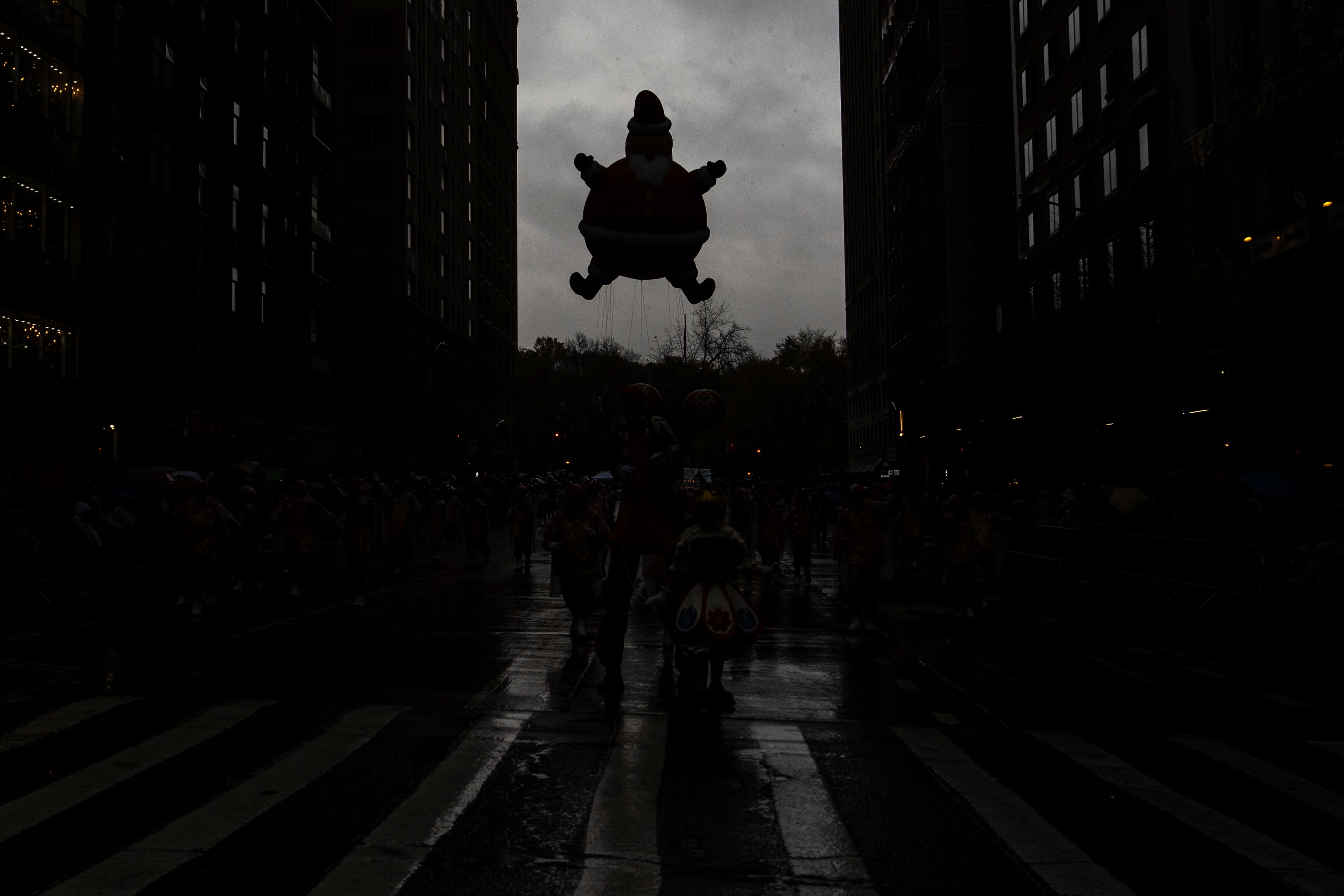 Handlers guide a Santa Claus balloon down Sixth Avenue during the Macy's Thanksgiving Day Parade, Thursday, Nov. 28, 2024, in New York. (AP Photo/Julia Demaree Nikhinson)